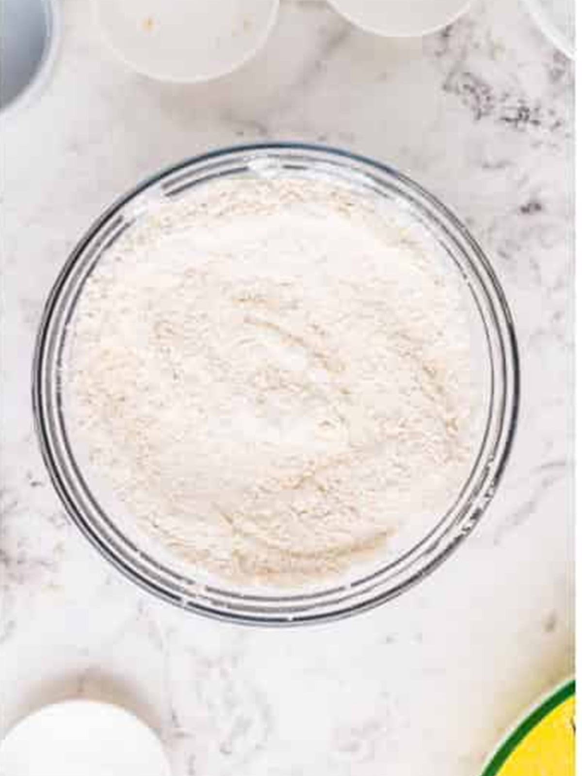 Flour, baking powder, and salt mixed in a bowl for munchkins.