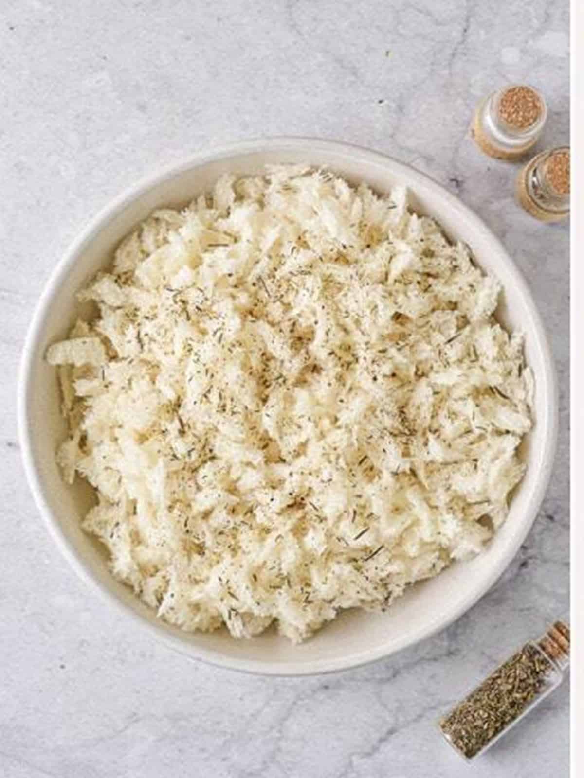 Panko bread crumbs seasoned with salt, pepper, and herbs in a bowl.