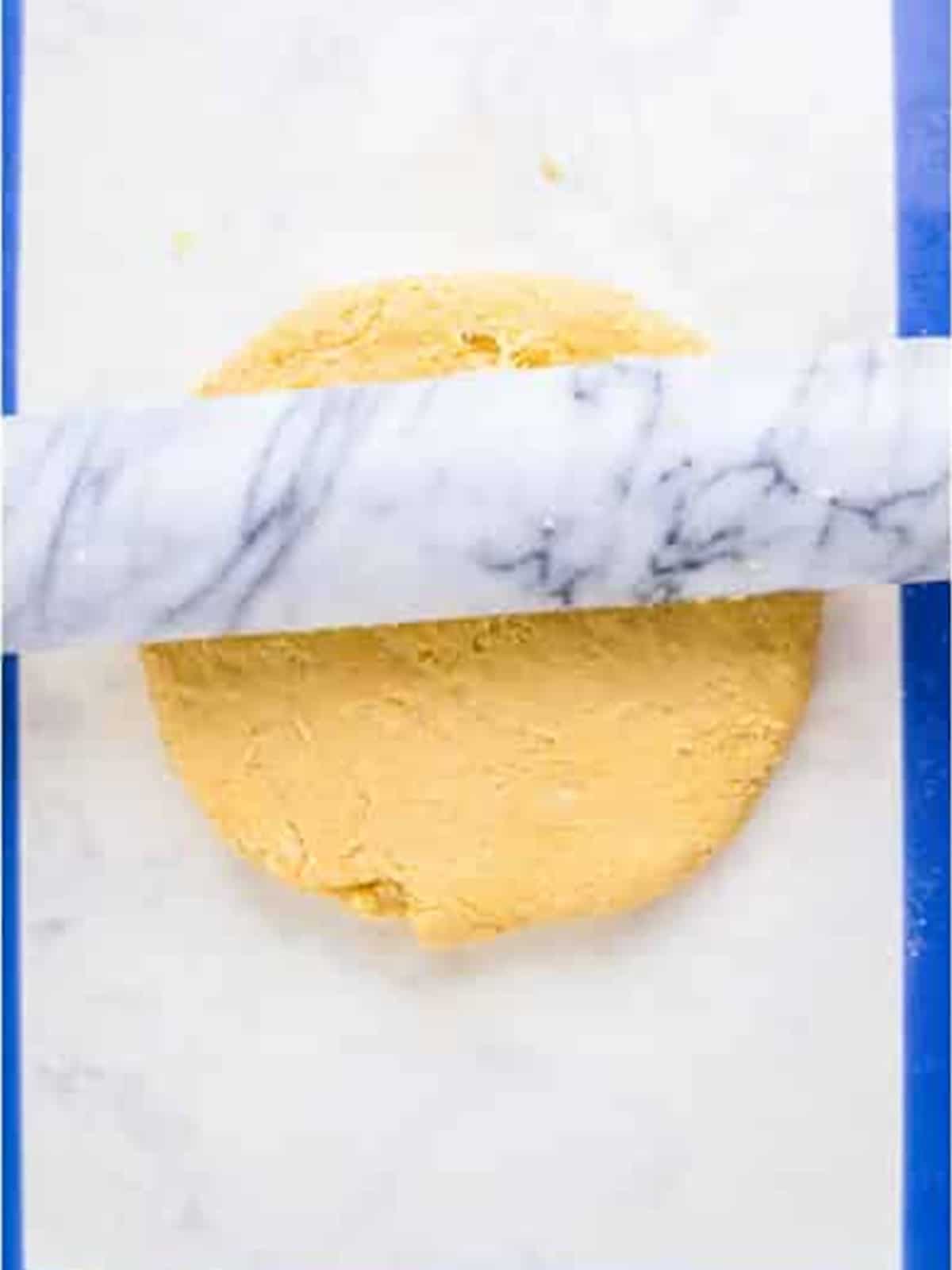 Munchkin dough rolled out flat on a work surface.