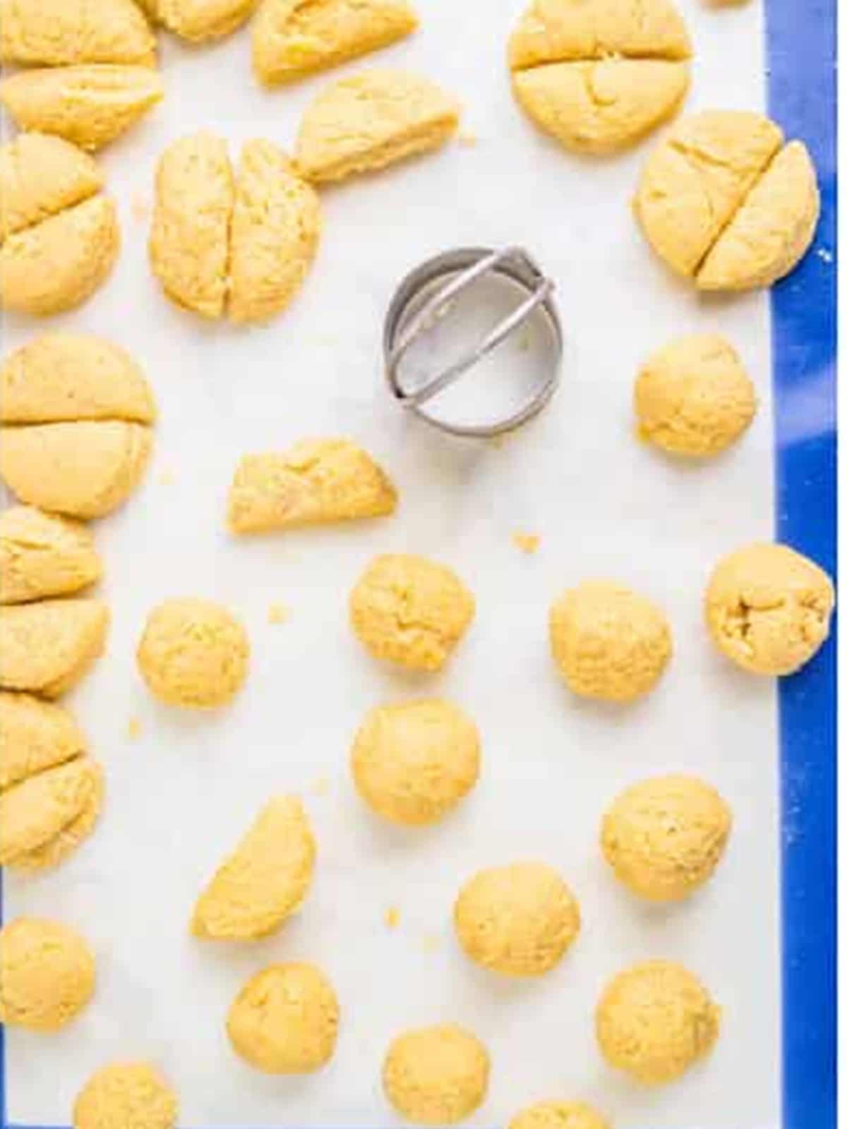 Dough cut into rounds and rolled into balls for munchkins.