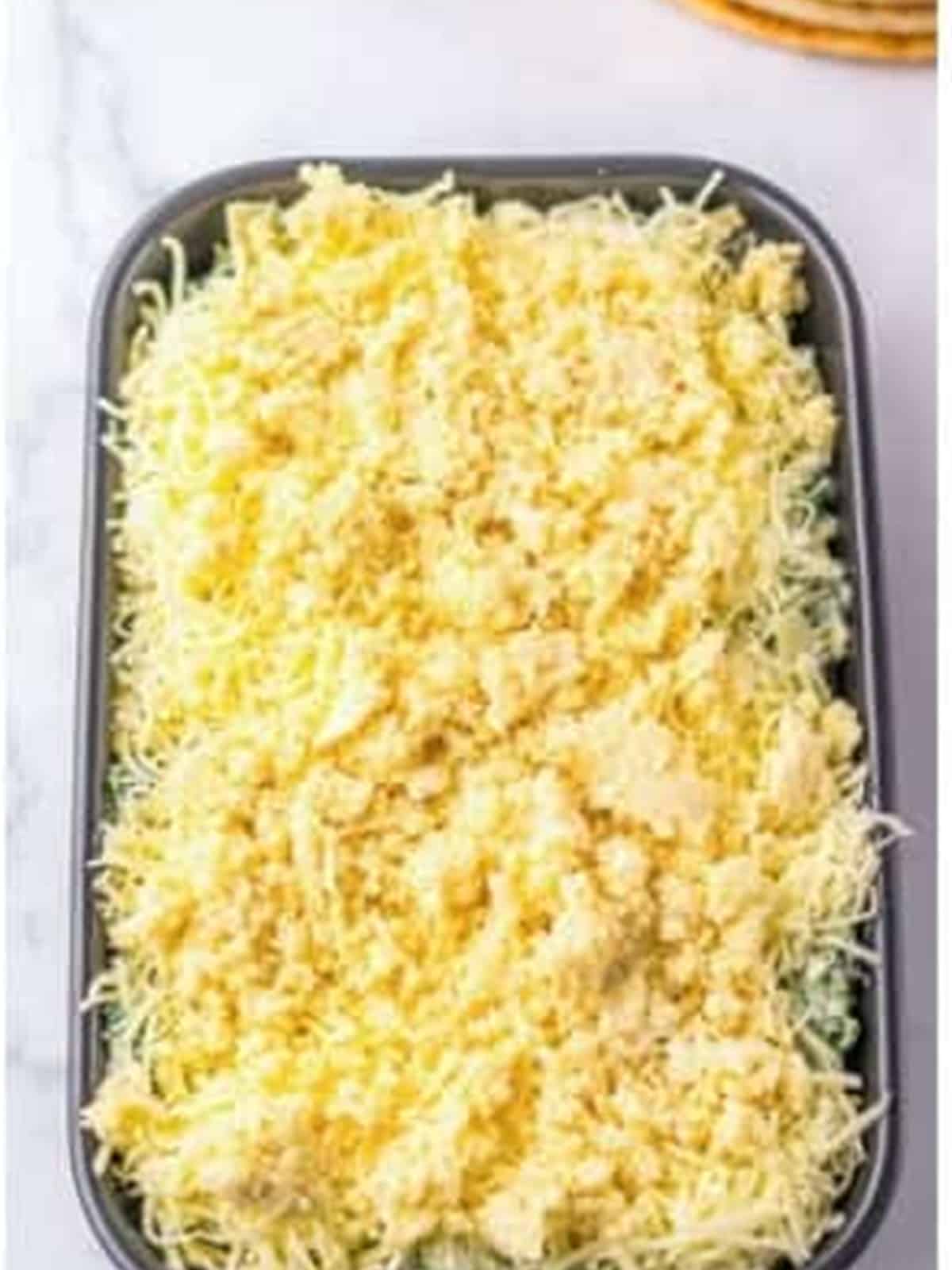 Panko topping spread over the cheesy spinach dip before baking.