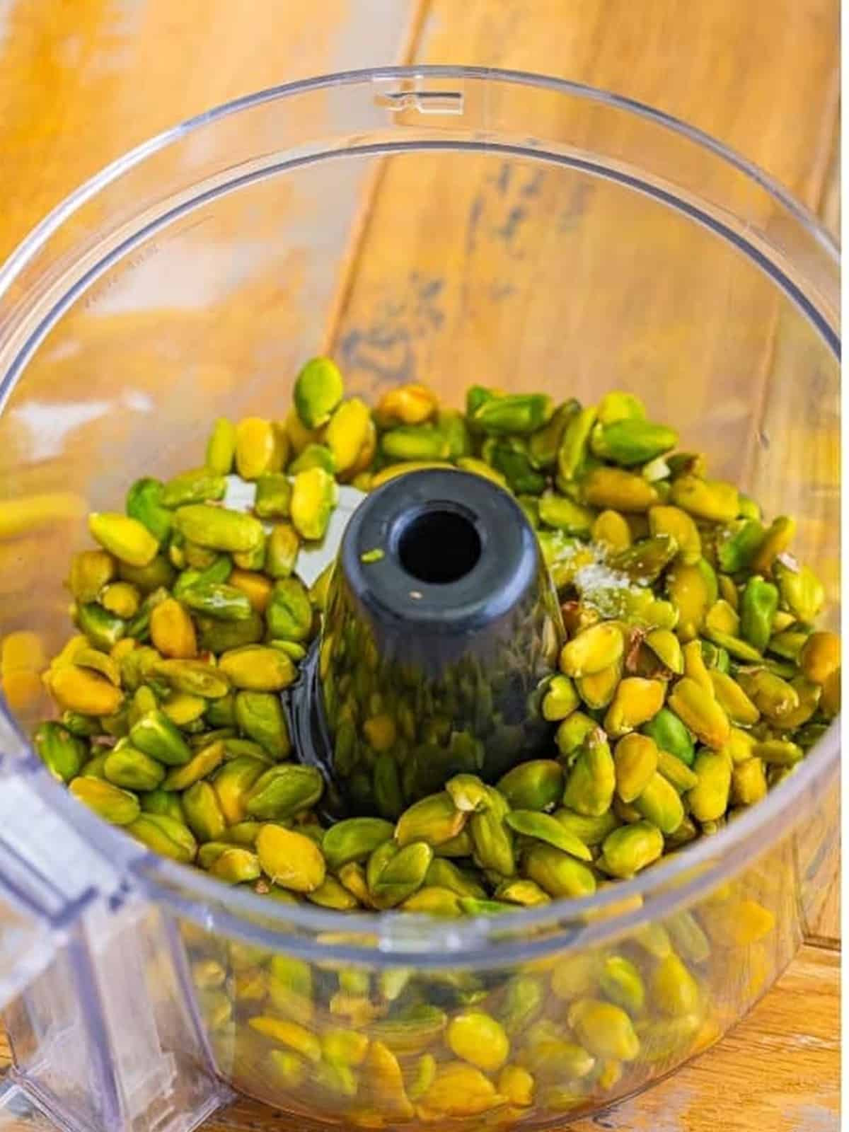 Pistachios in a food processor before blending into pistachio cream.