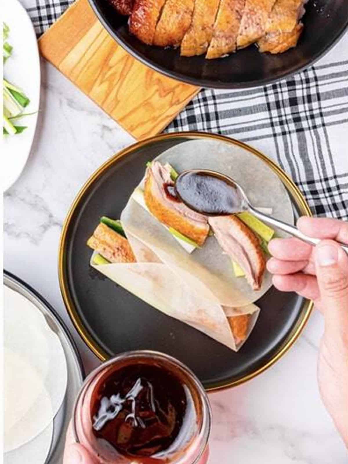 Assembled Peking duck pancake with hoisin sauce ready to serve.