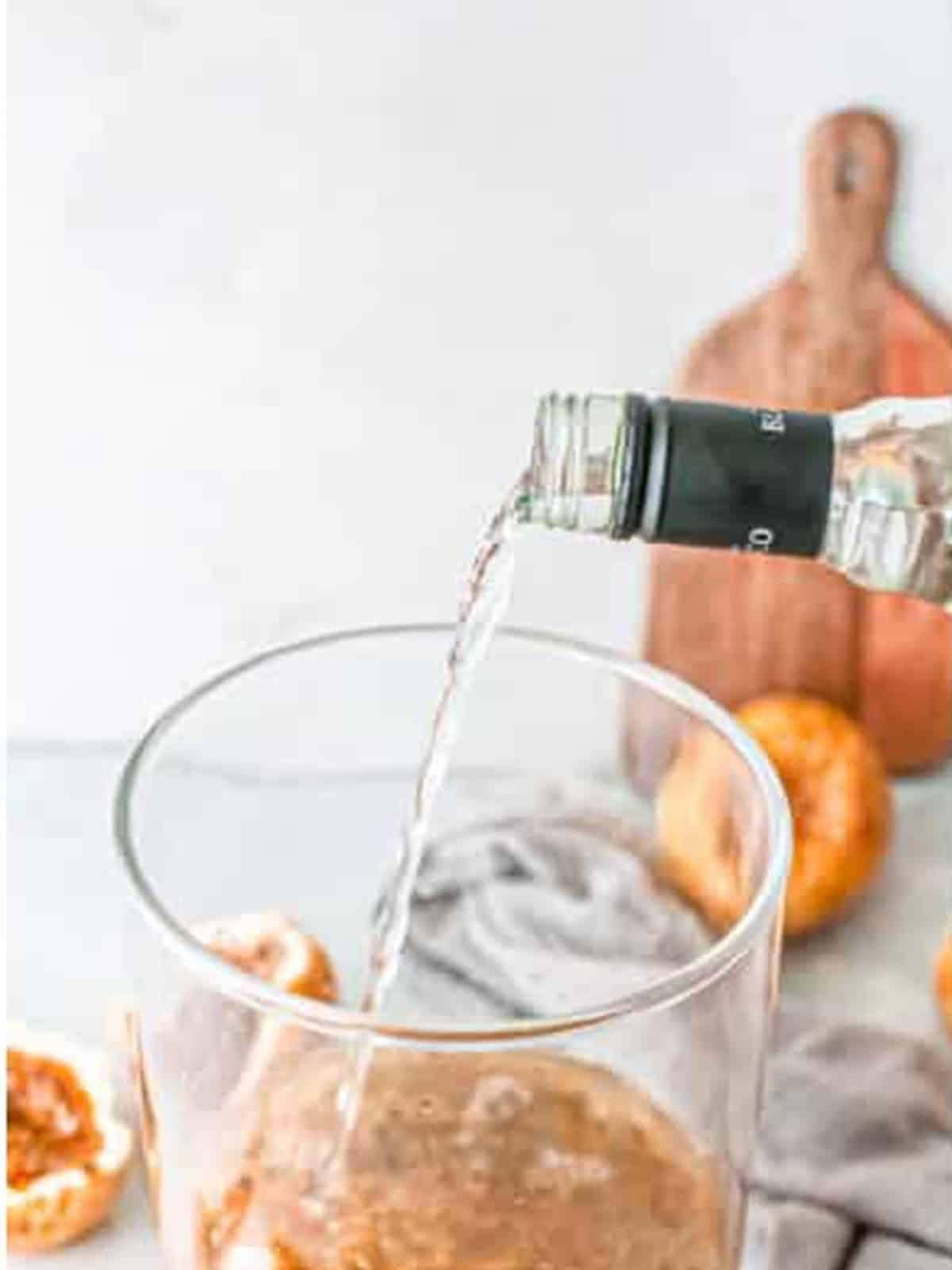 Adding cointreau to the passion fruit margarita pitcher.