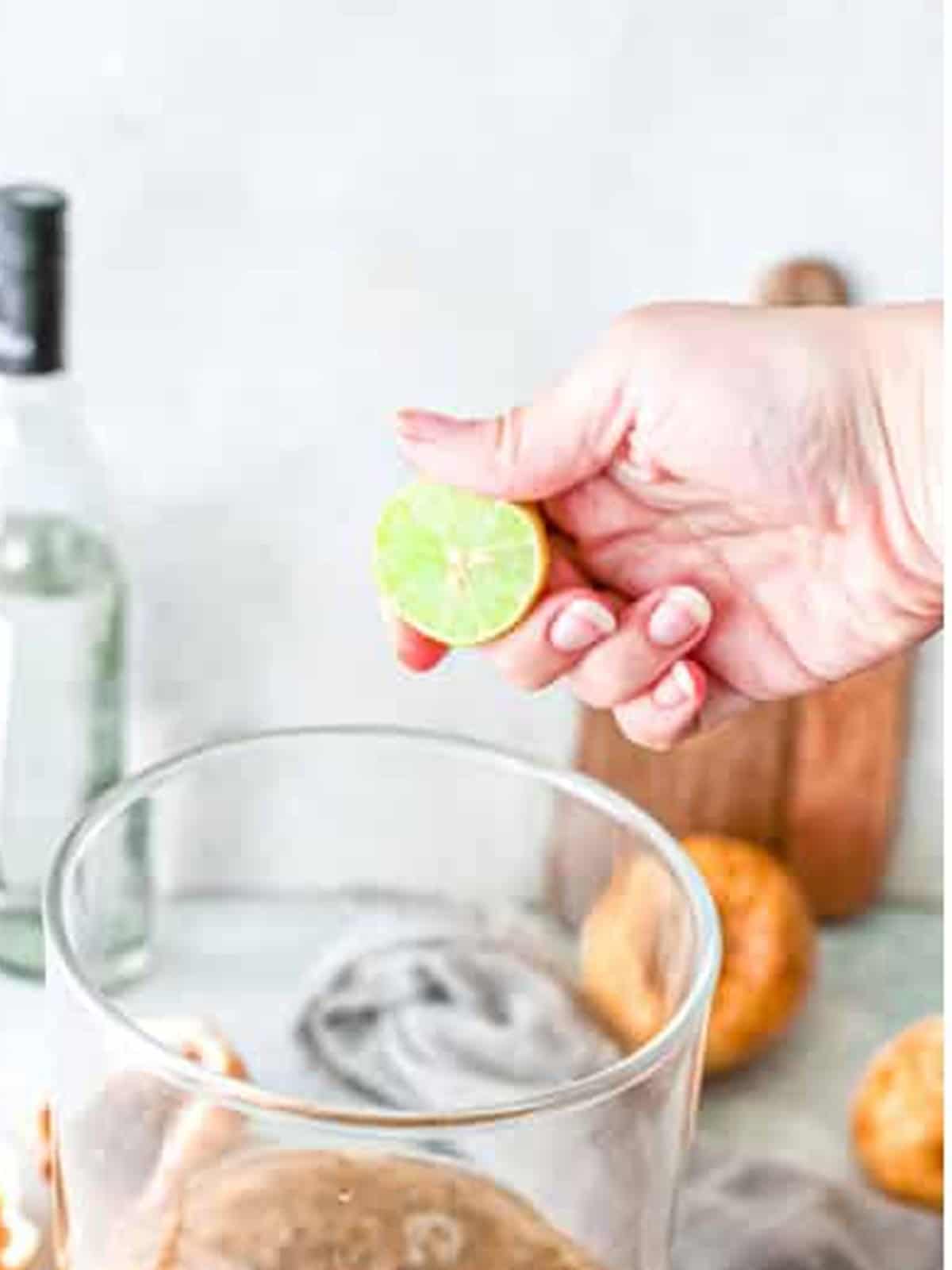 Squeezing fresh lime juice into the passion fruit margarita.