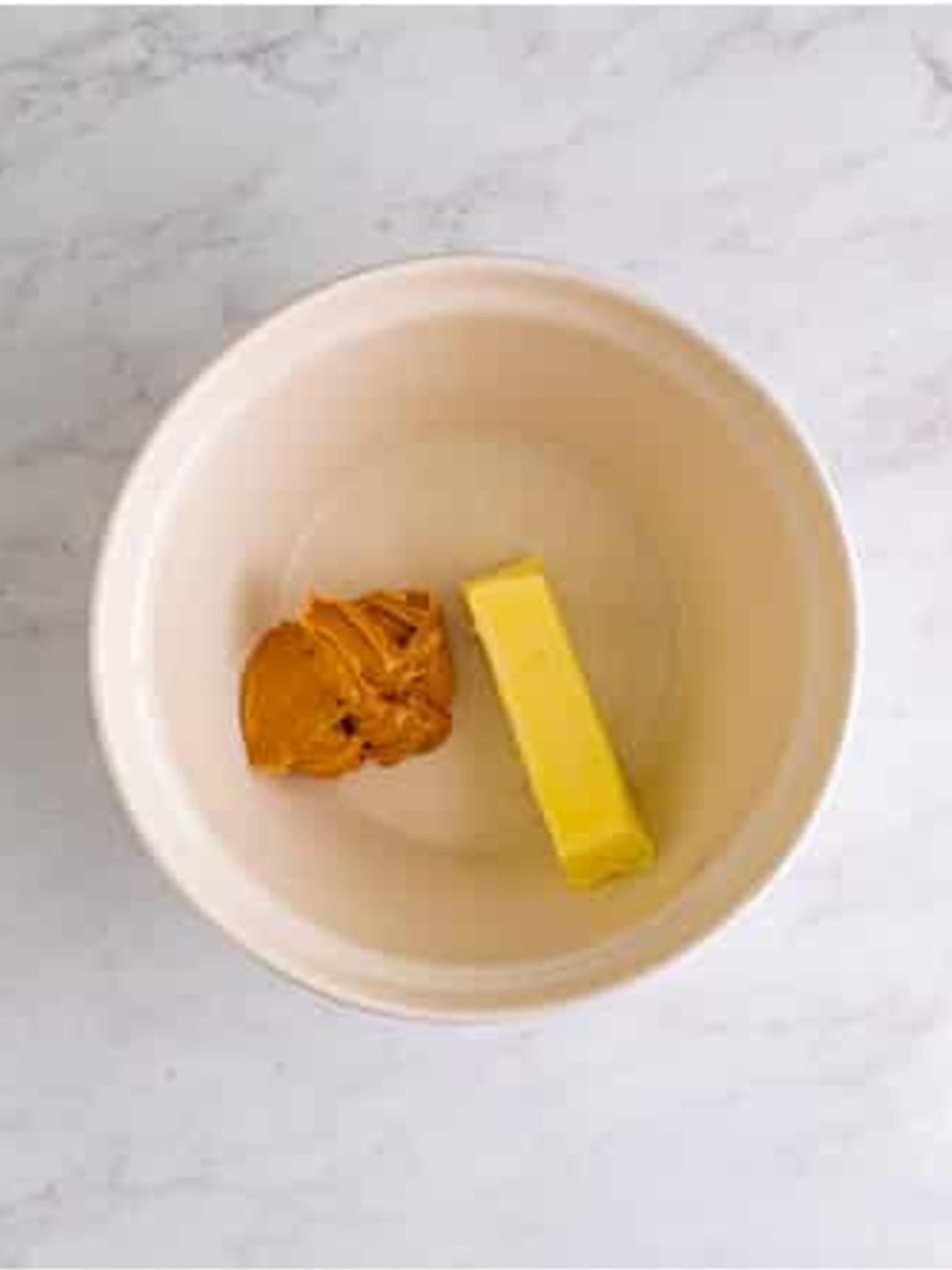 Creaming butter and peanut butter for Peanut Butter Chocolate Chip Cookie Bars.