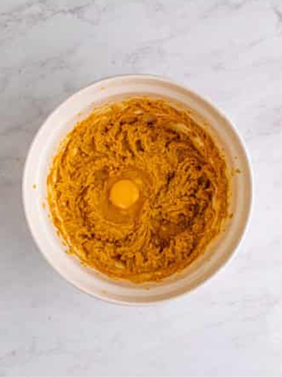 Beating eggs into the Peanut Butter Chocolate Chip Cookie Bars batter.