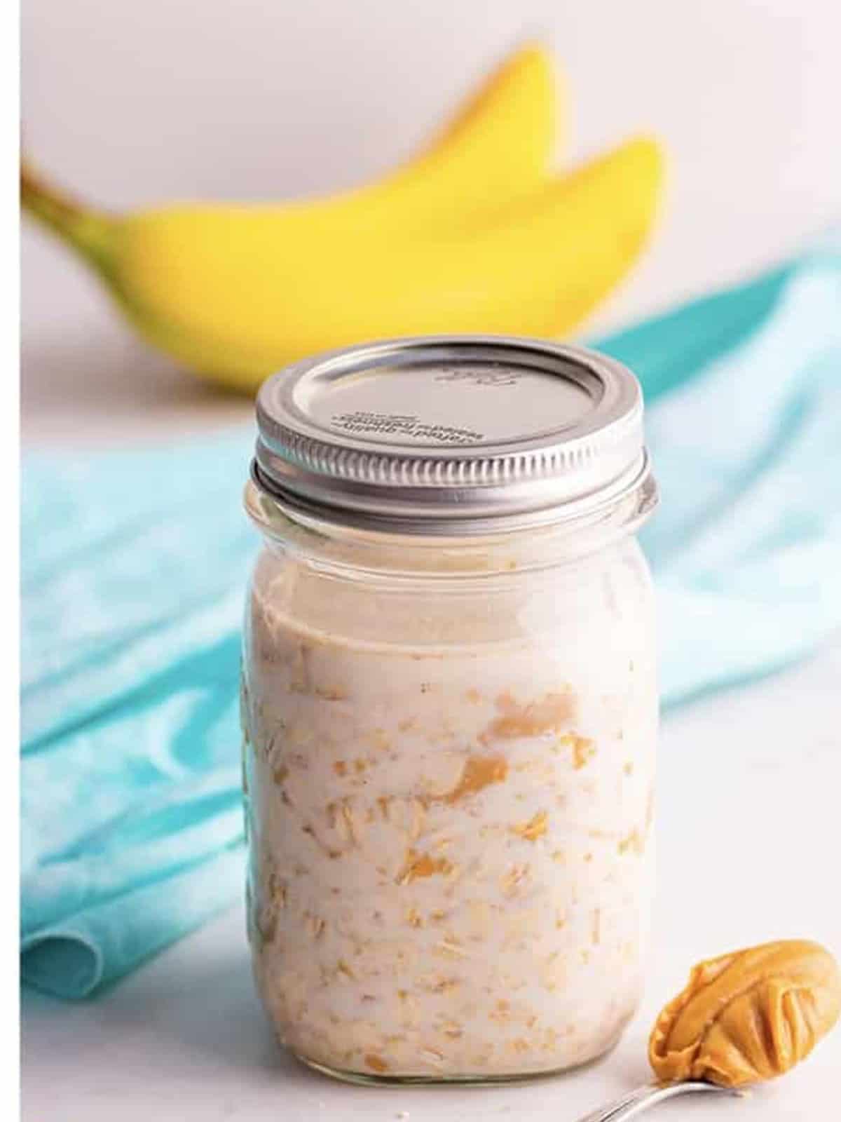 A sealed mason jar of peanut butter overnight oats ready to refrigerate.