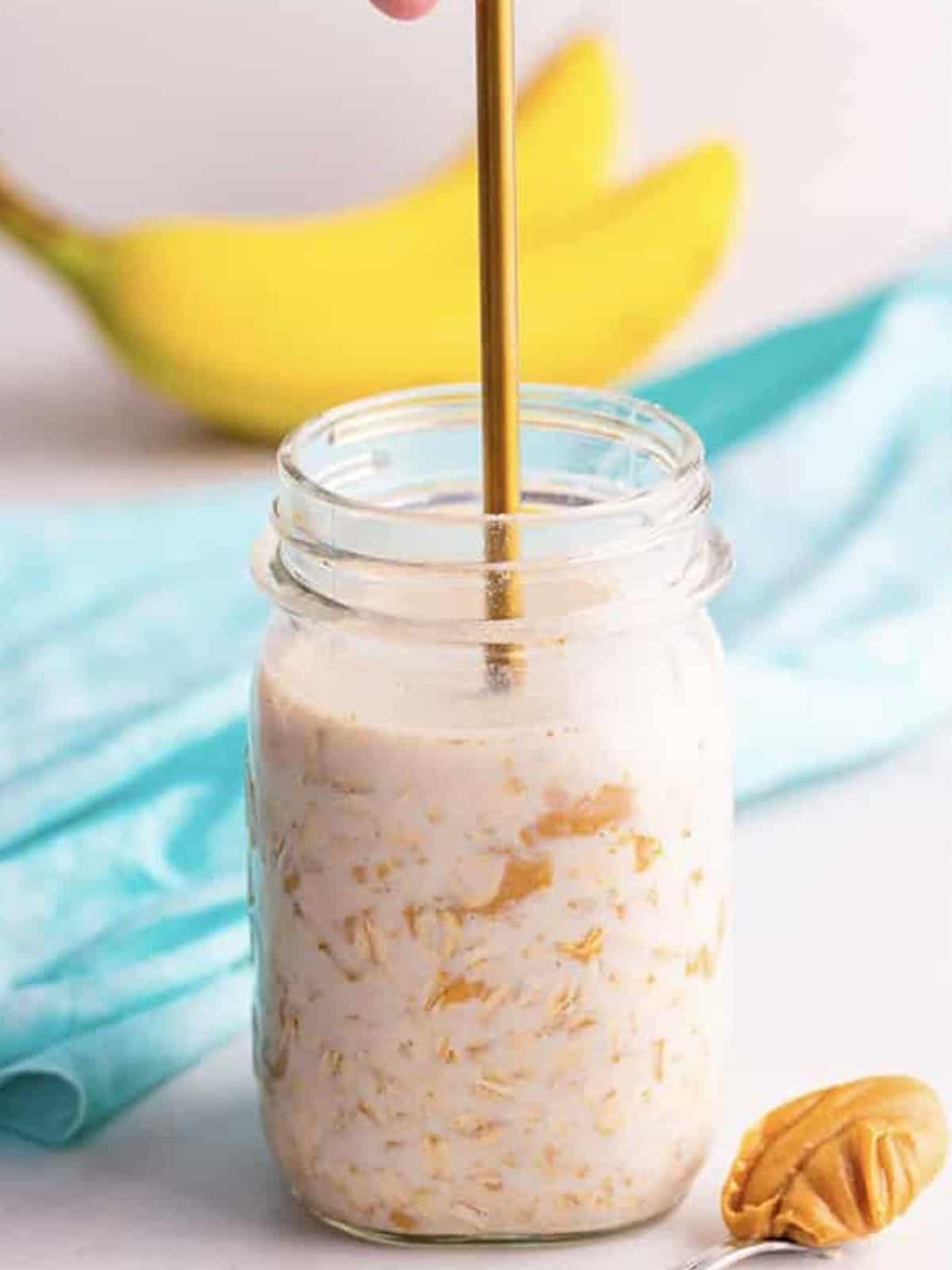 Oats stirred and pressed into the liquid in a mason jar.