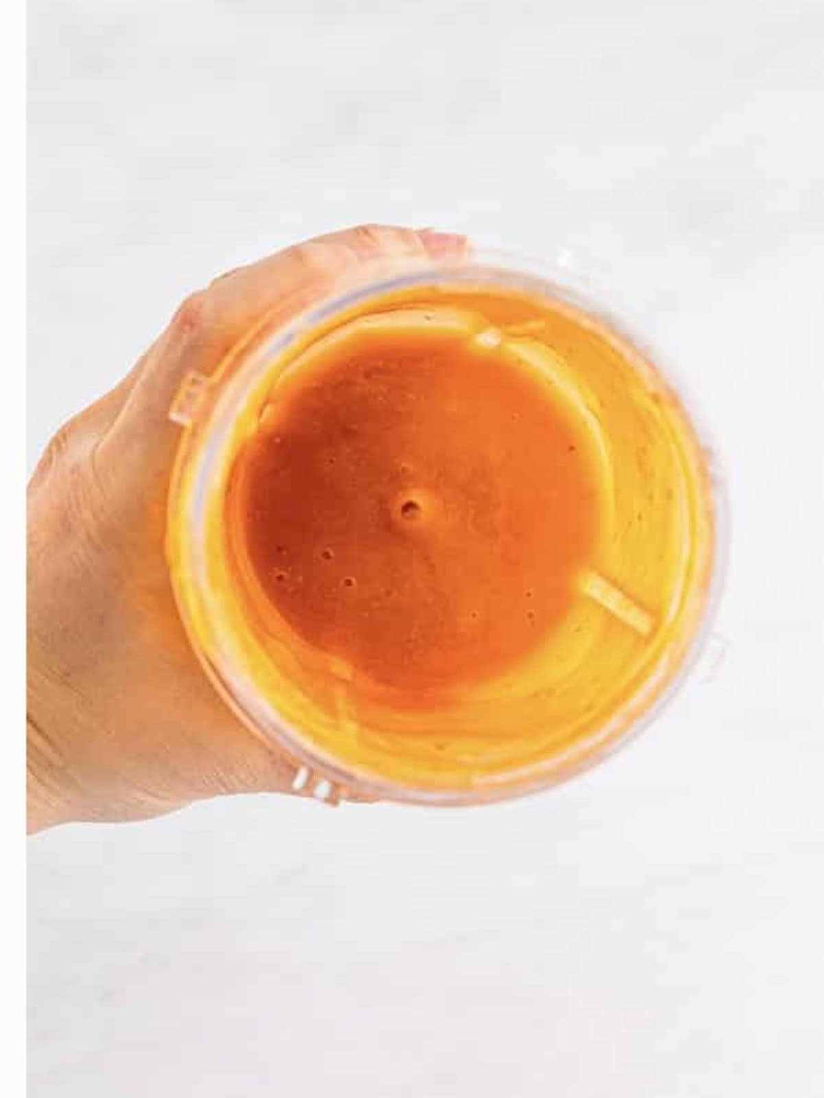 Smooth blended peach and raspberry puree for a peach bellini.