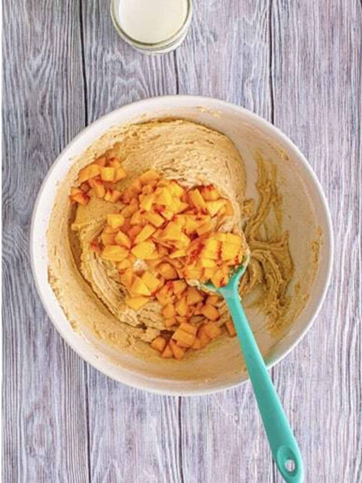 Diced fresh peaches folded into peach bread batter.