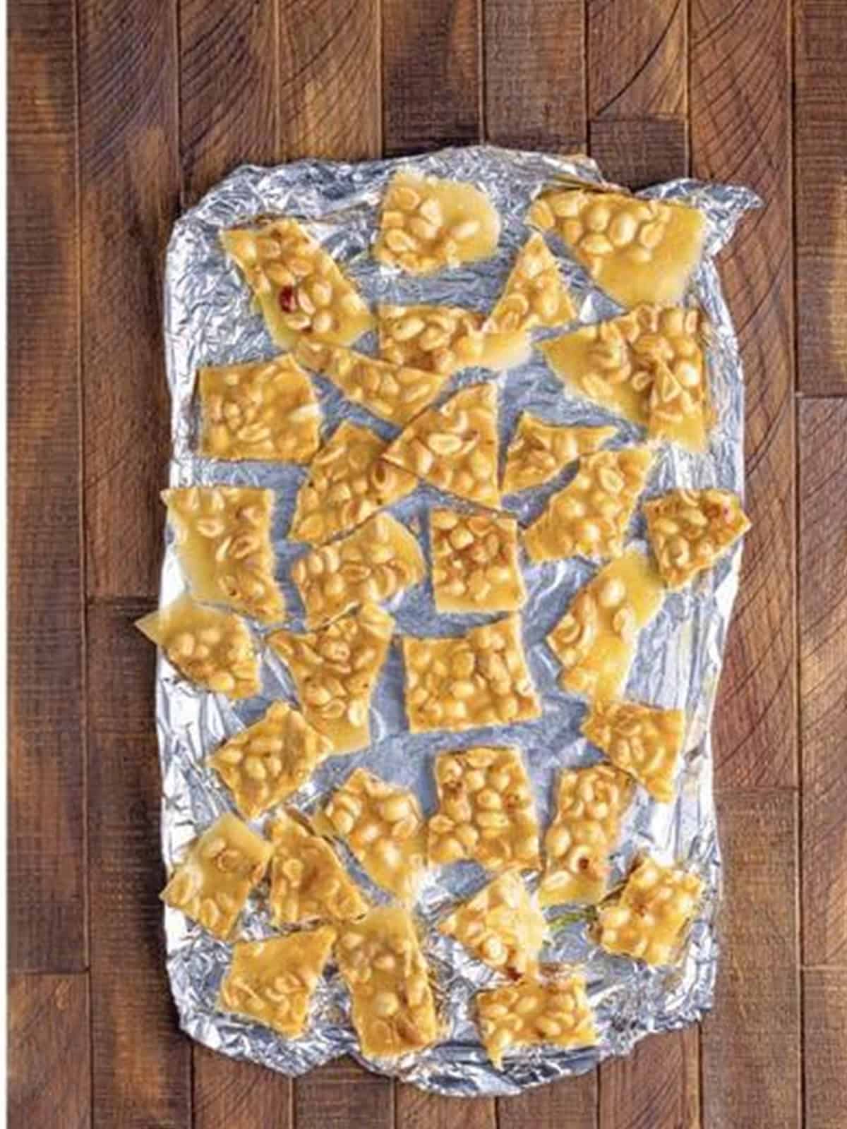 Hardened microwave peanut brittle on the tray ready to break into pieces.