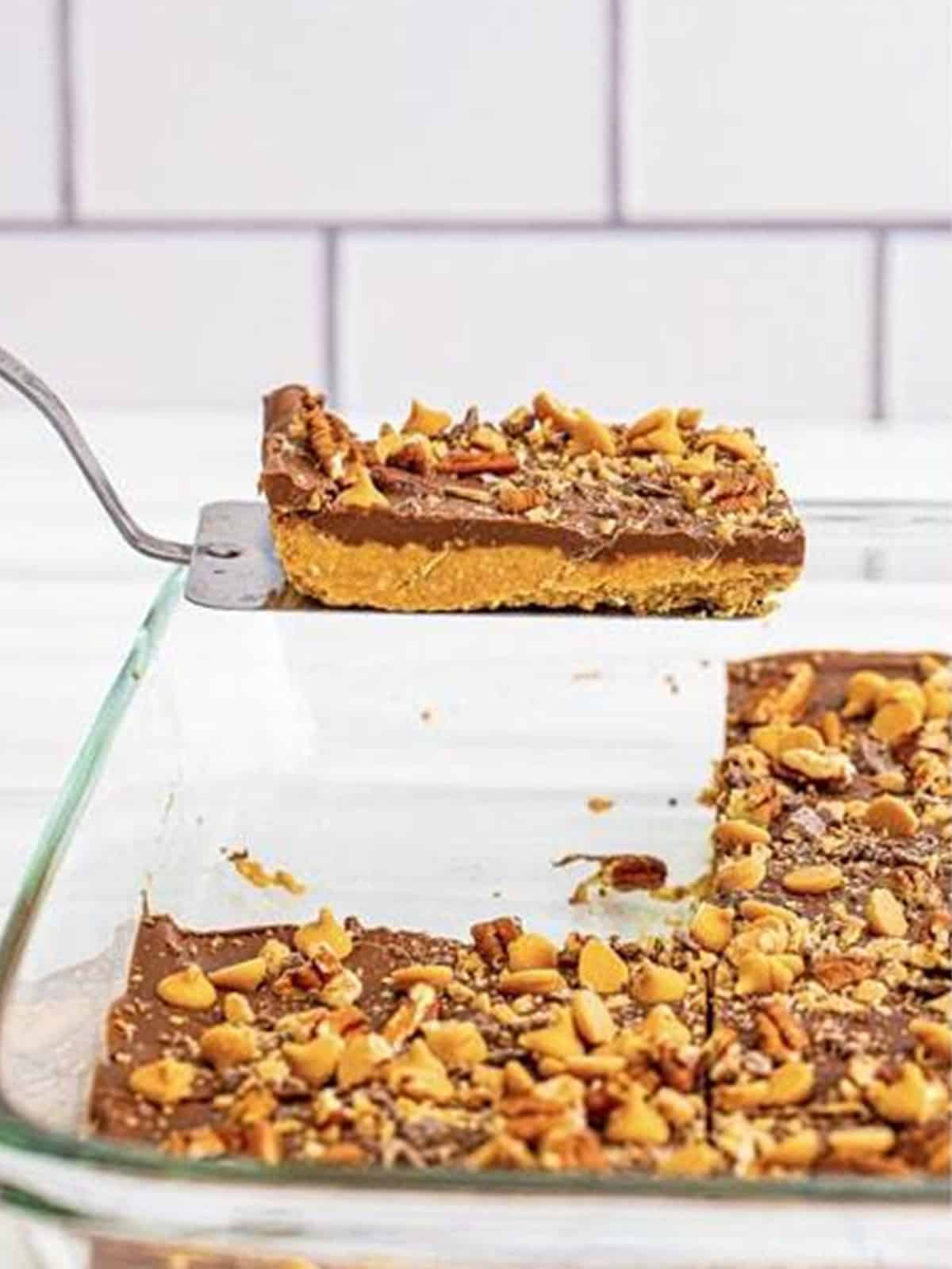 No-bake peanut butter bars cut into squares with chocolate and toffee topping.
