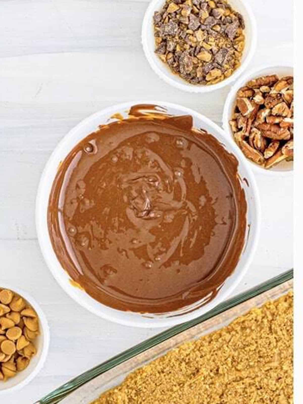Melted chocolate and peanut butter stirred smooth in a bowl.