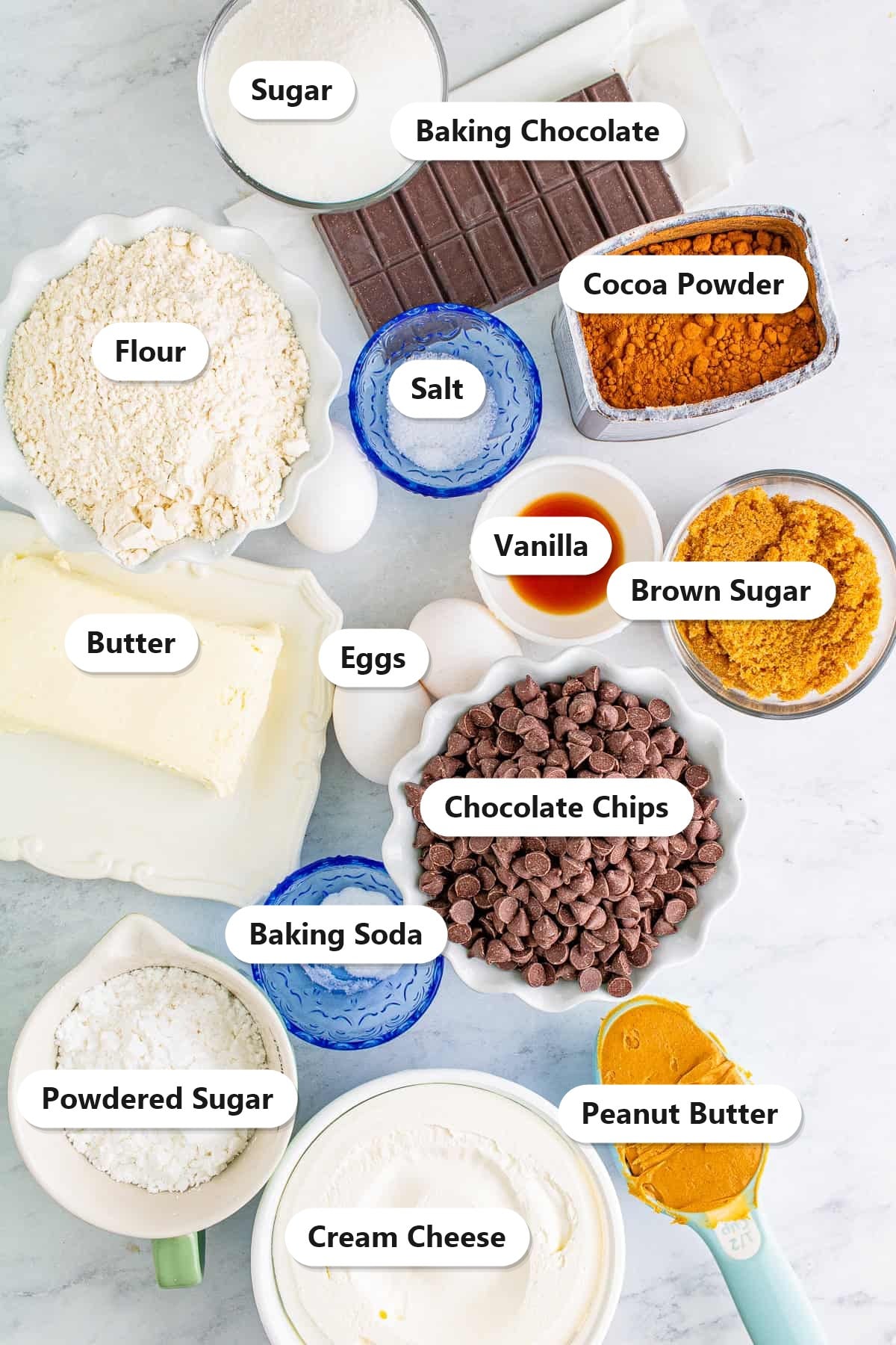Labeled ingredients for peanut butter brownies including flour, sugar, cocoa, baking chocolate, chocolate chips, butter, eggs, cream cheese, peanut butter, and powdered sugar.