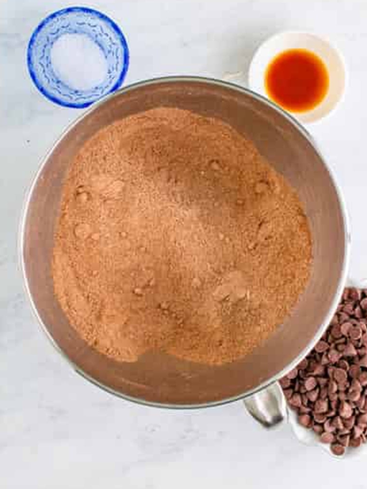Brownie batter mixed in a stand mixer bowl for peanut butter brownies.