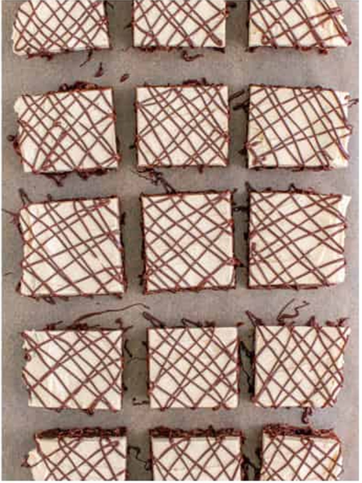 Finished peanut butter brownies cut into bars and drizzled with chocolate.