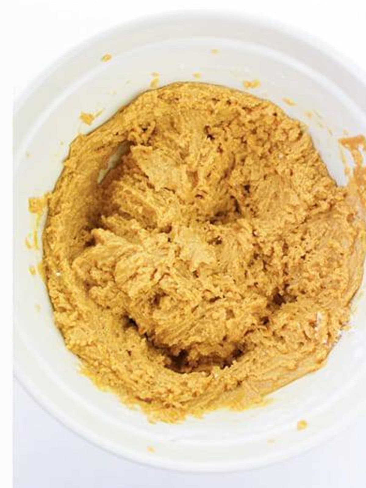Smooth peanut butter cookie dough in a bowl.