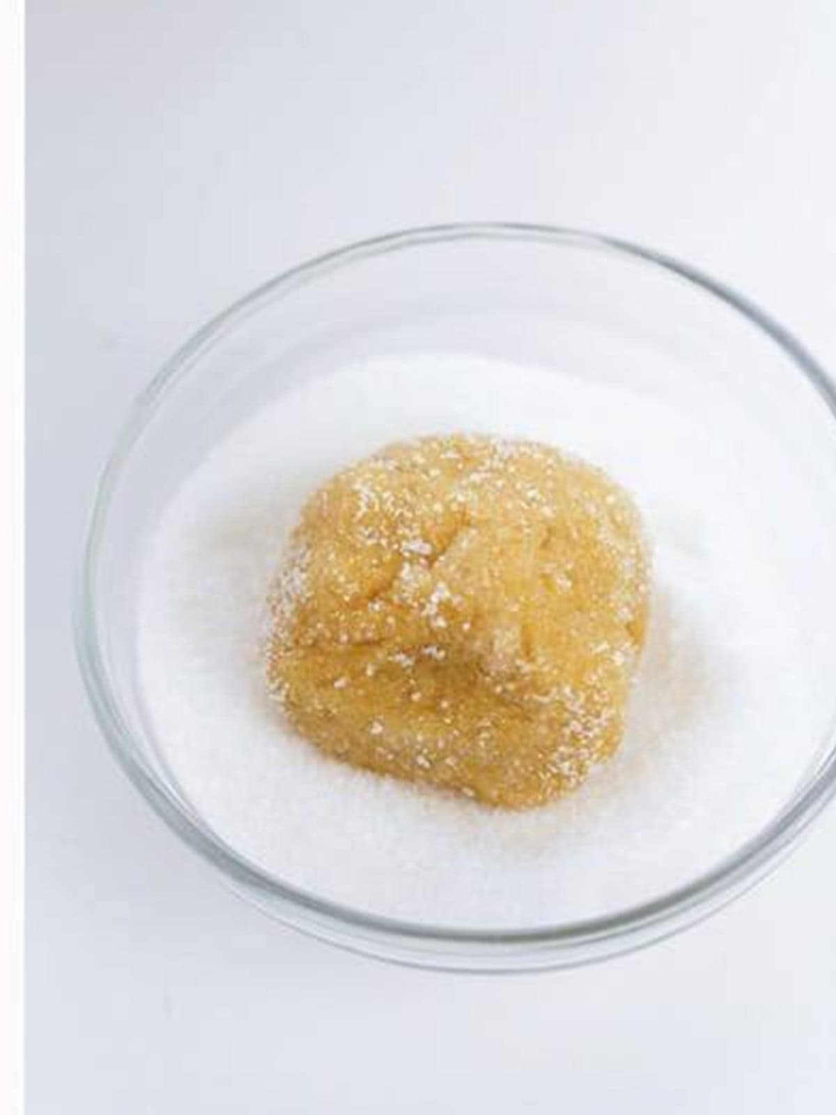 A cookie dough ball rolled in granulated sugar.