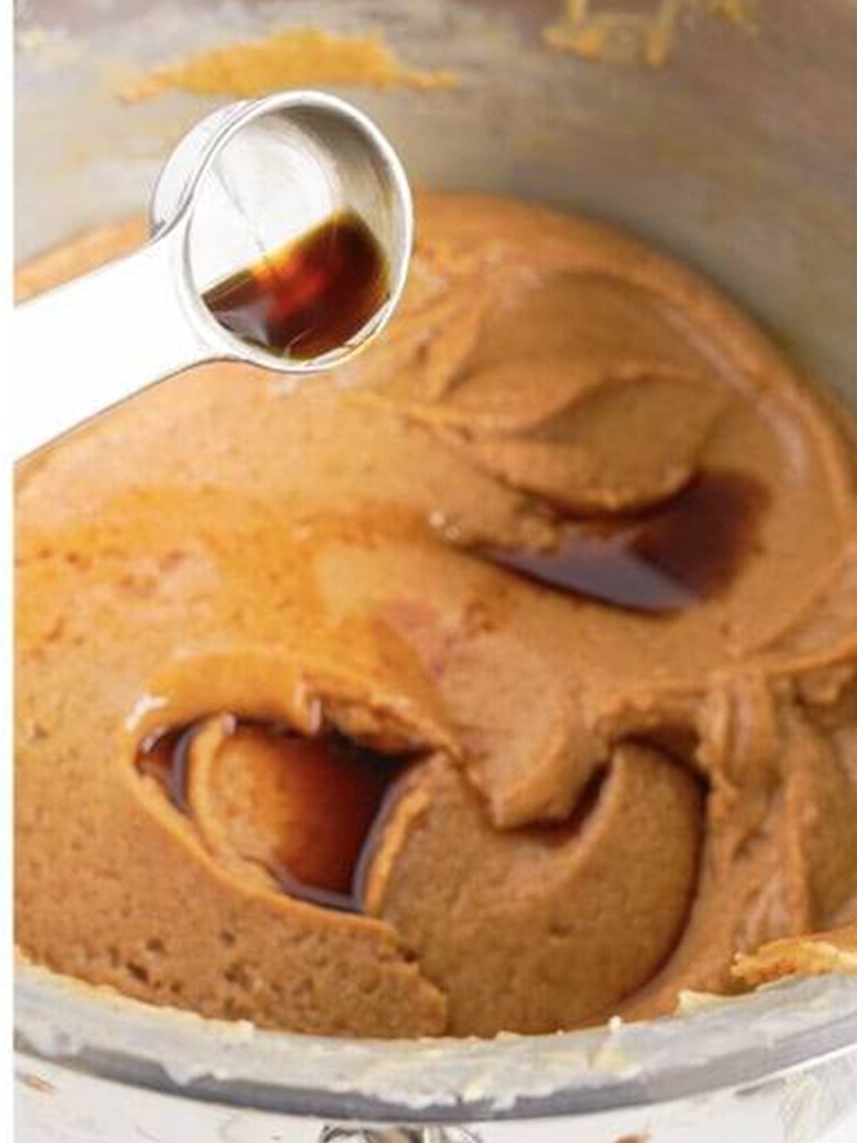 Stirring vanilla into the warm peanut butter fudge mixture.