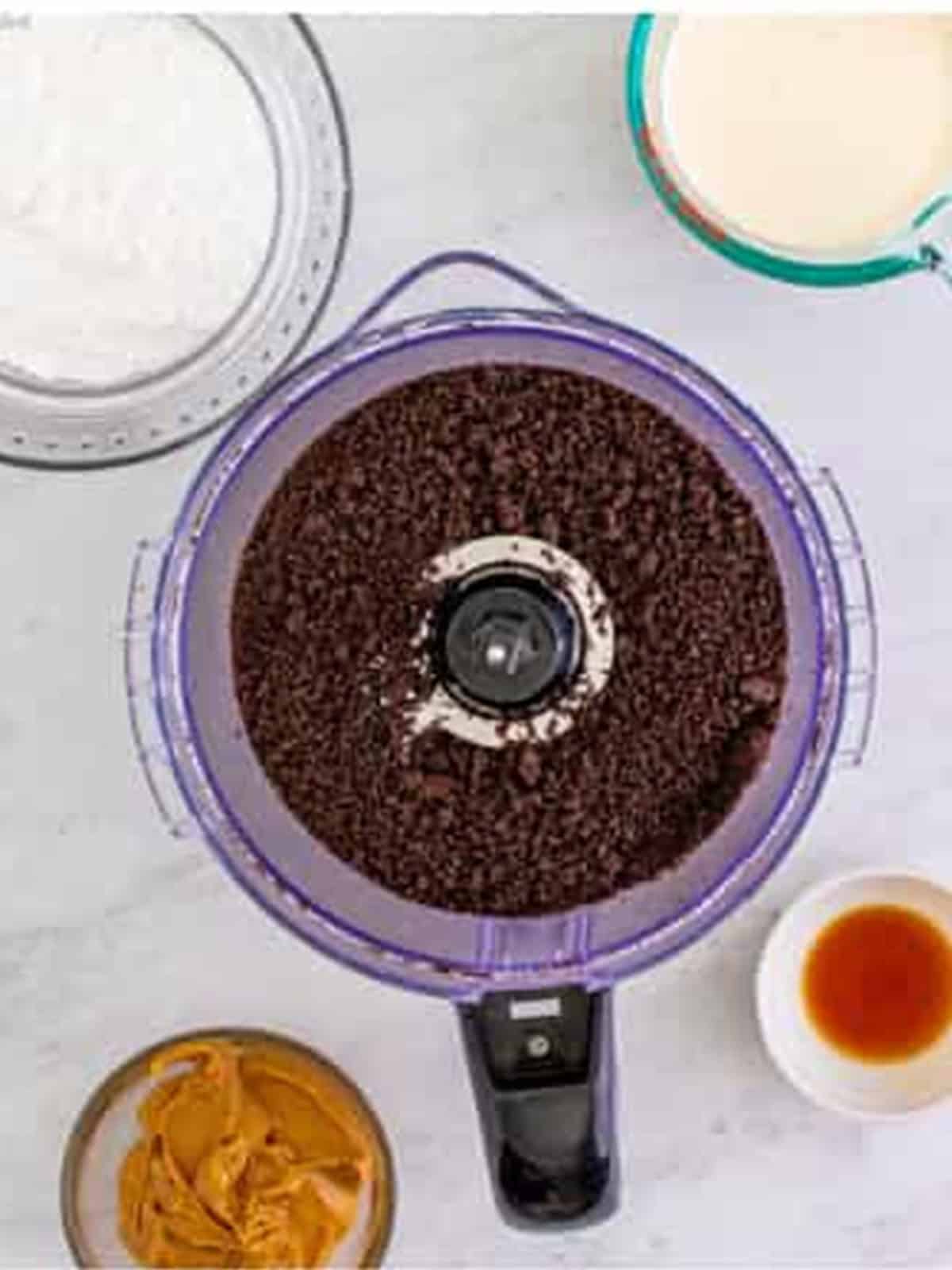Oreos crushed into fine crumbs in a food processor for a no bake peanut butter pie crust.