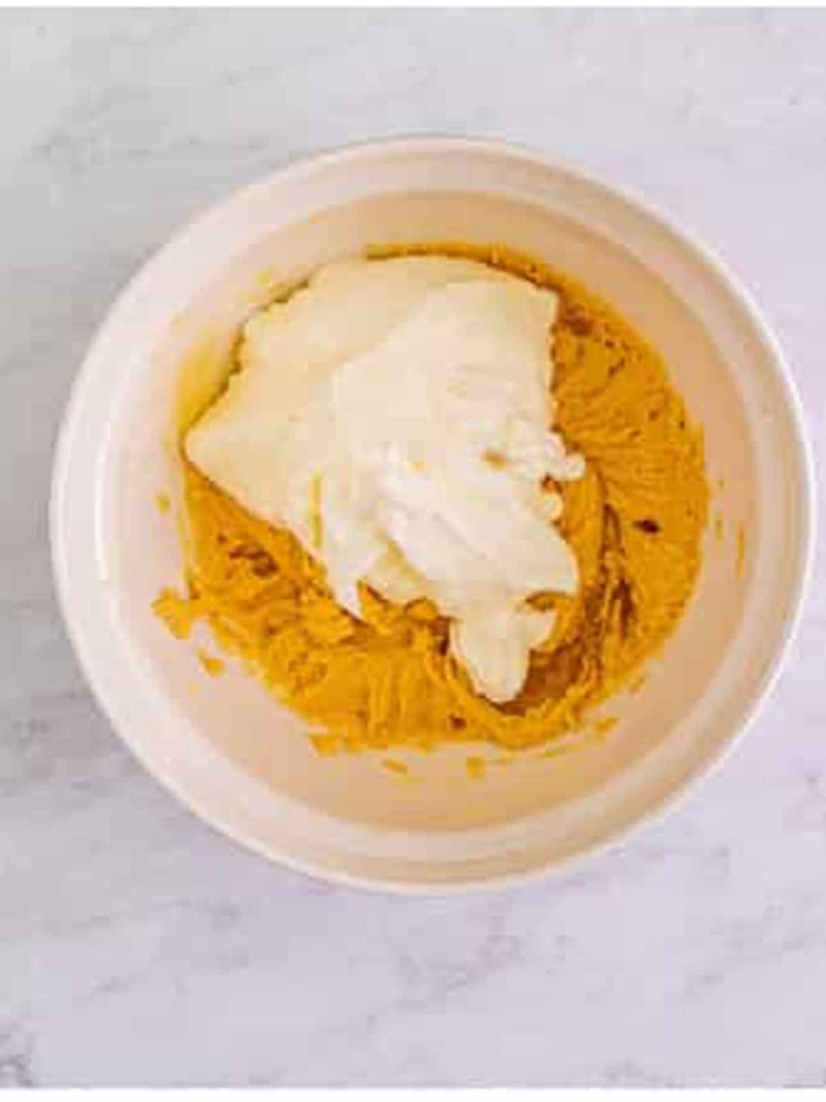 Folding whipped cream into the peanut butter pie filling.
