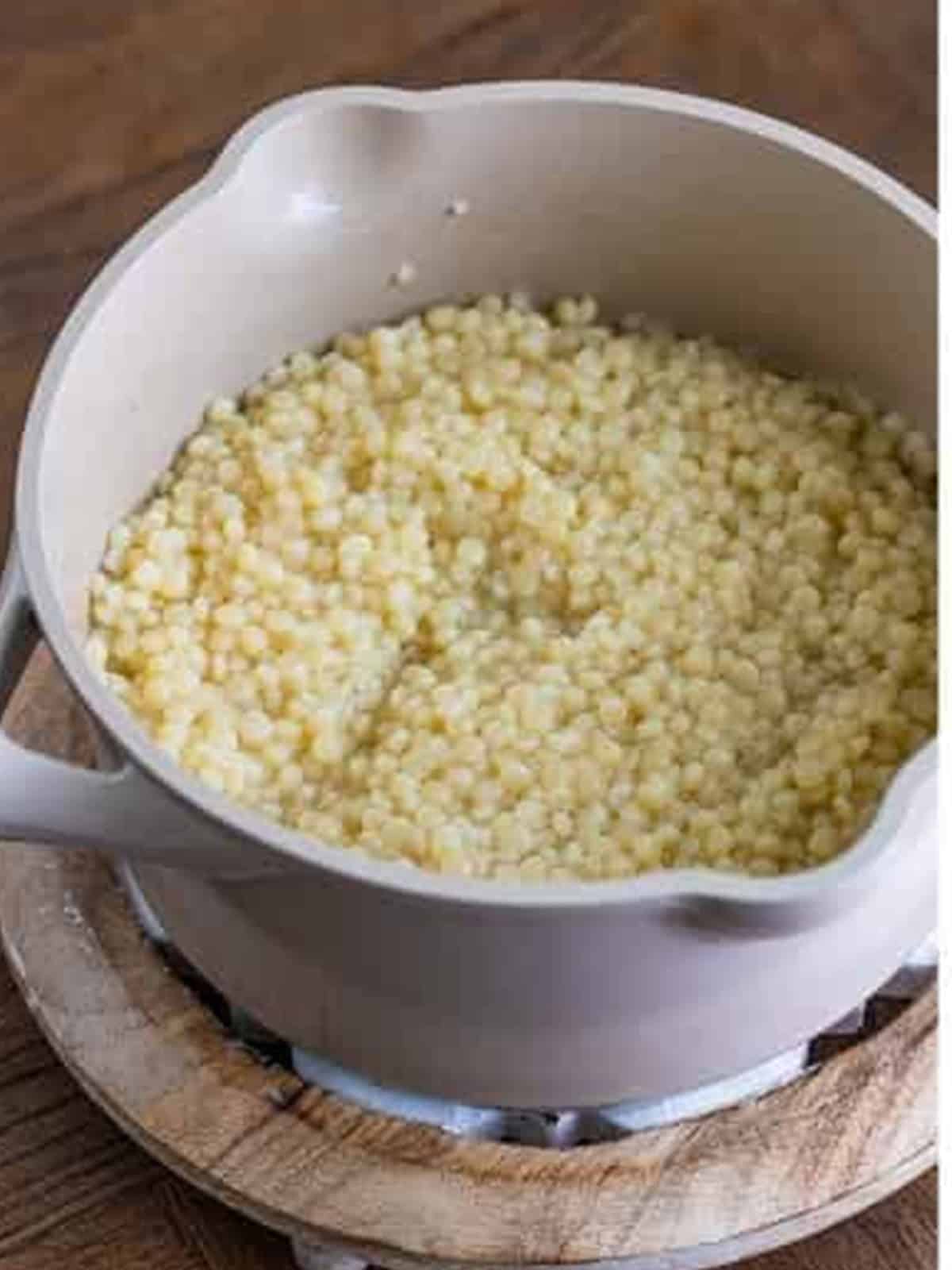 Pearl couscous simmering in a pot of water for pearl couscous salad.