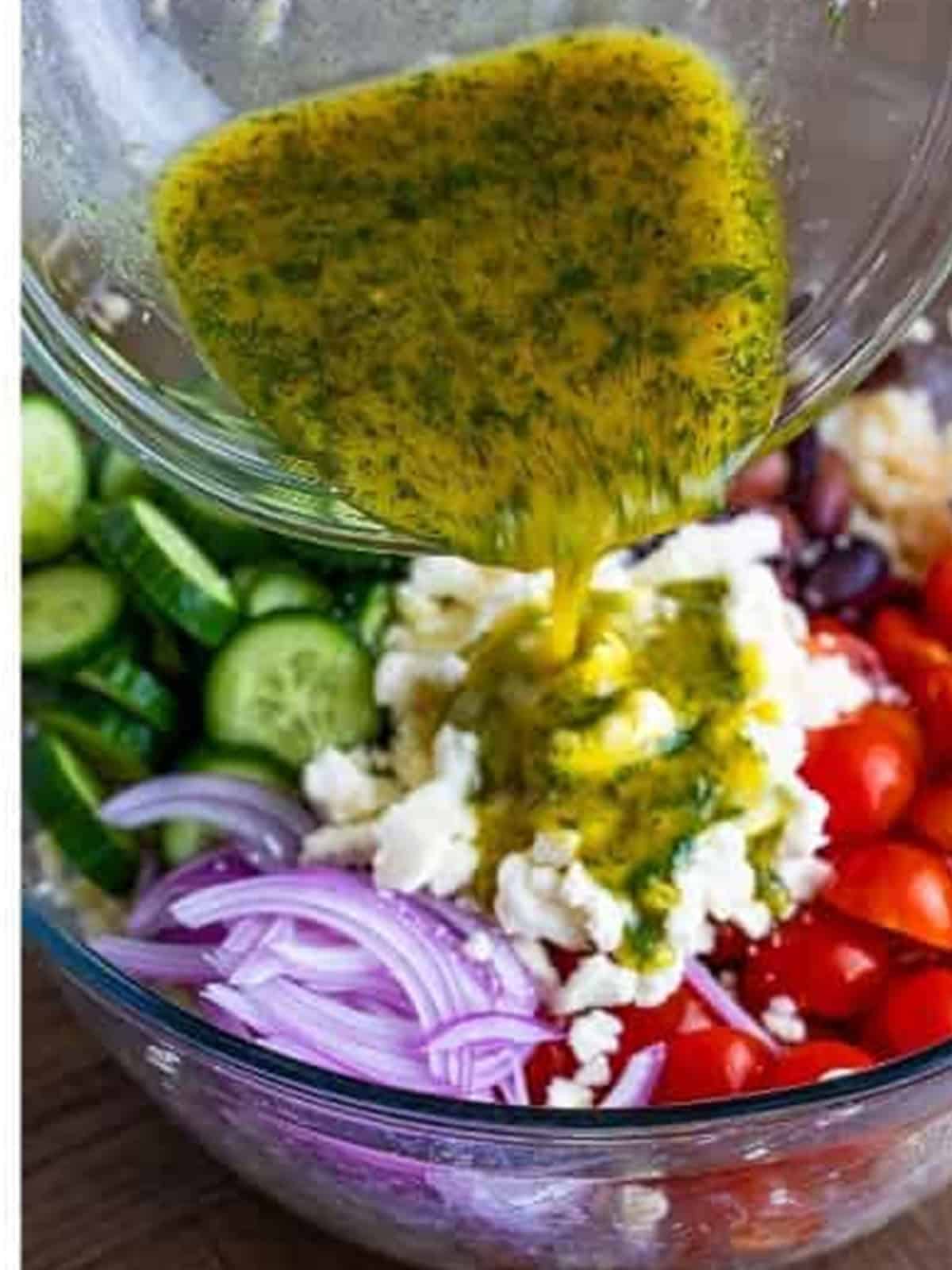 Lemon dill dressing poured over the pearl couscous salad before tossing.