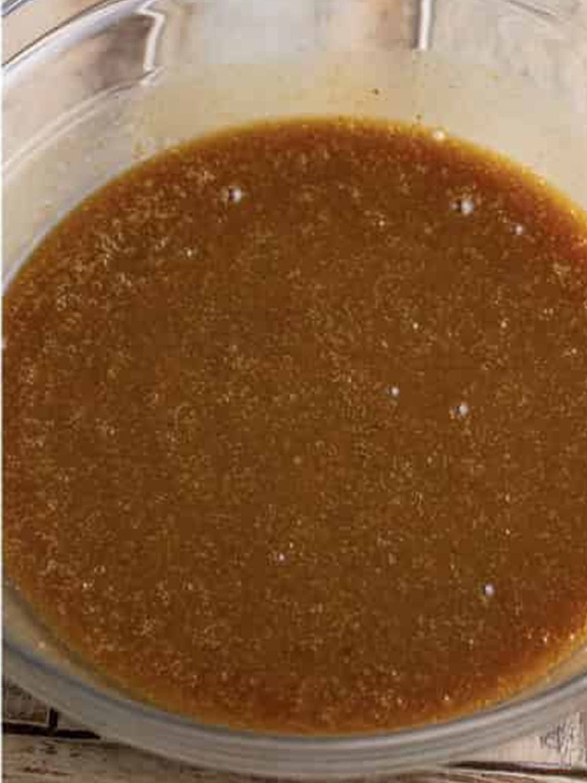 Syrup tempered into beaten eggs for pecan cobbler filling.