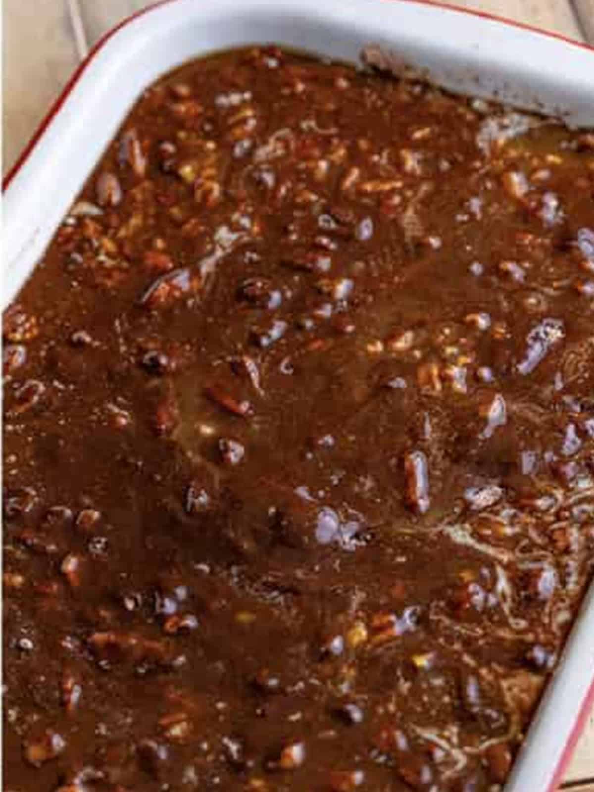 Melted butter poured over the brownie mix layer of pecan cobbler.