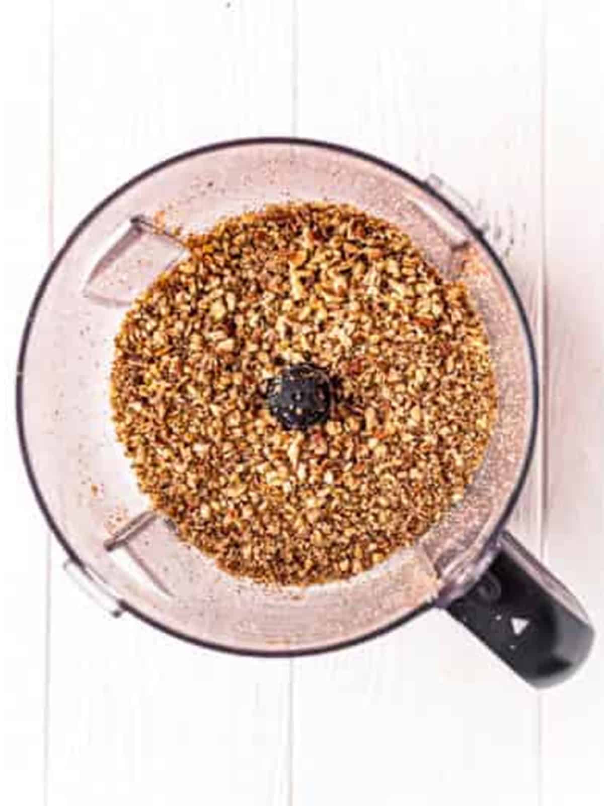 Roasted pecans added to a food processor to make pecan sandies.