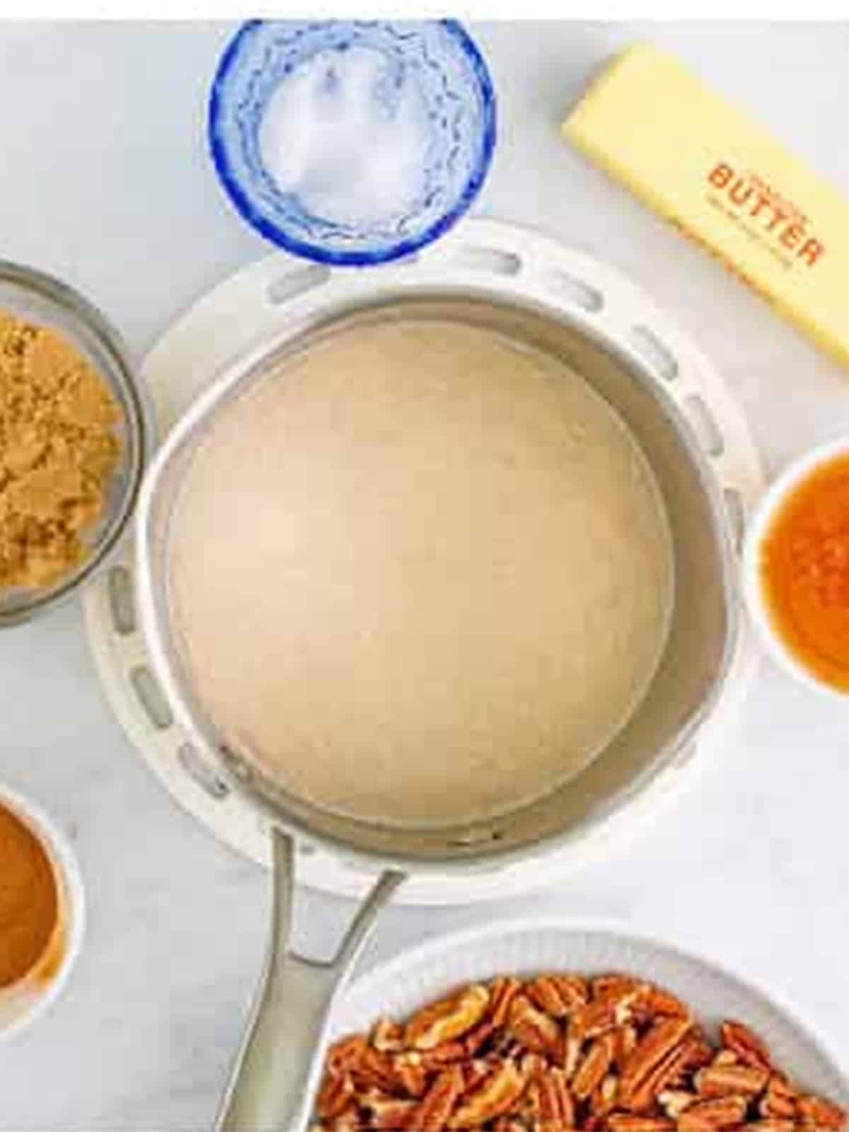 Active dry yeast blooming in warm milk in a saucepan.