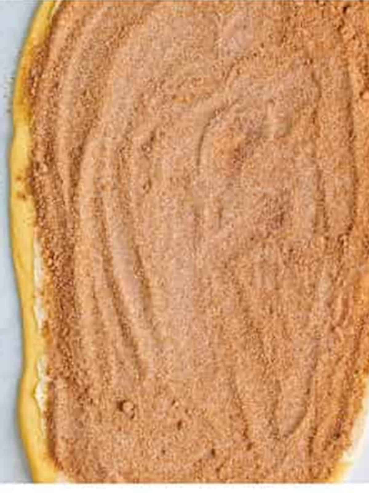 Soft butter and cinnamon sugar spread over the rolled out sticky bun dough.