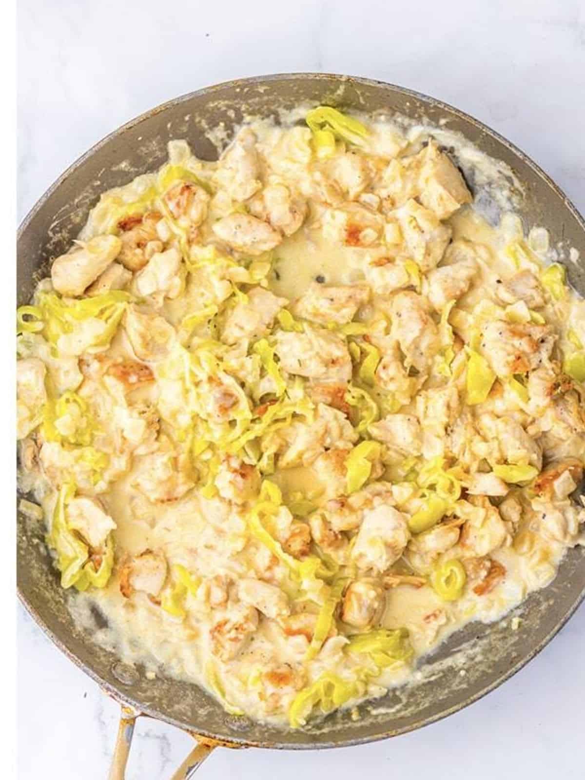 Cooked chicken stirred back into the creamy pepperoncini Parmesan sauce.
