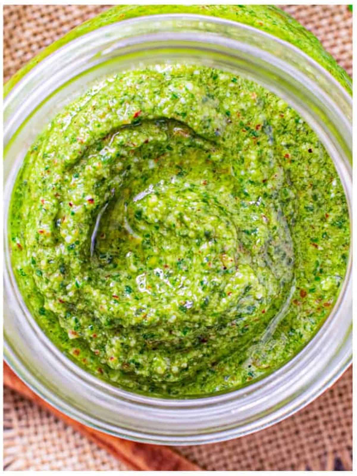 Smooth, bright green homemade pesto blended in a bowl.