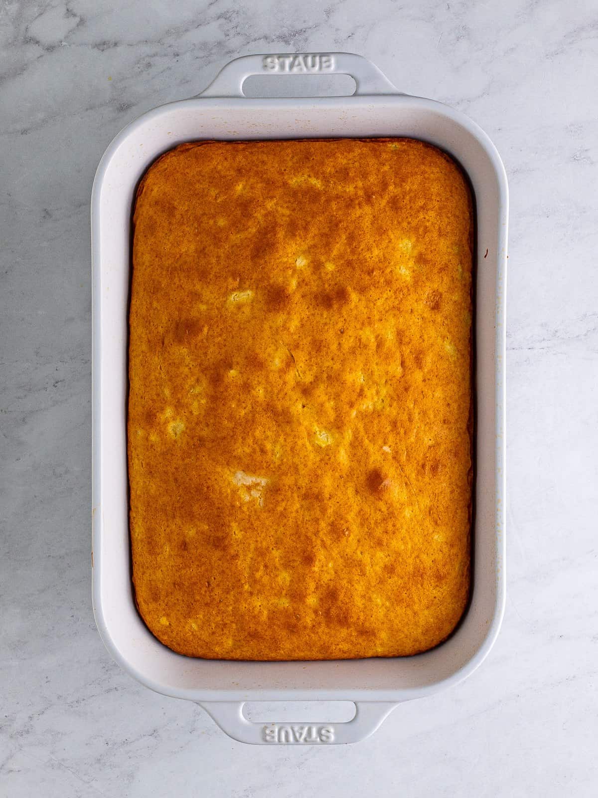 Baked cake in a pan for Pina Colada Cake.
