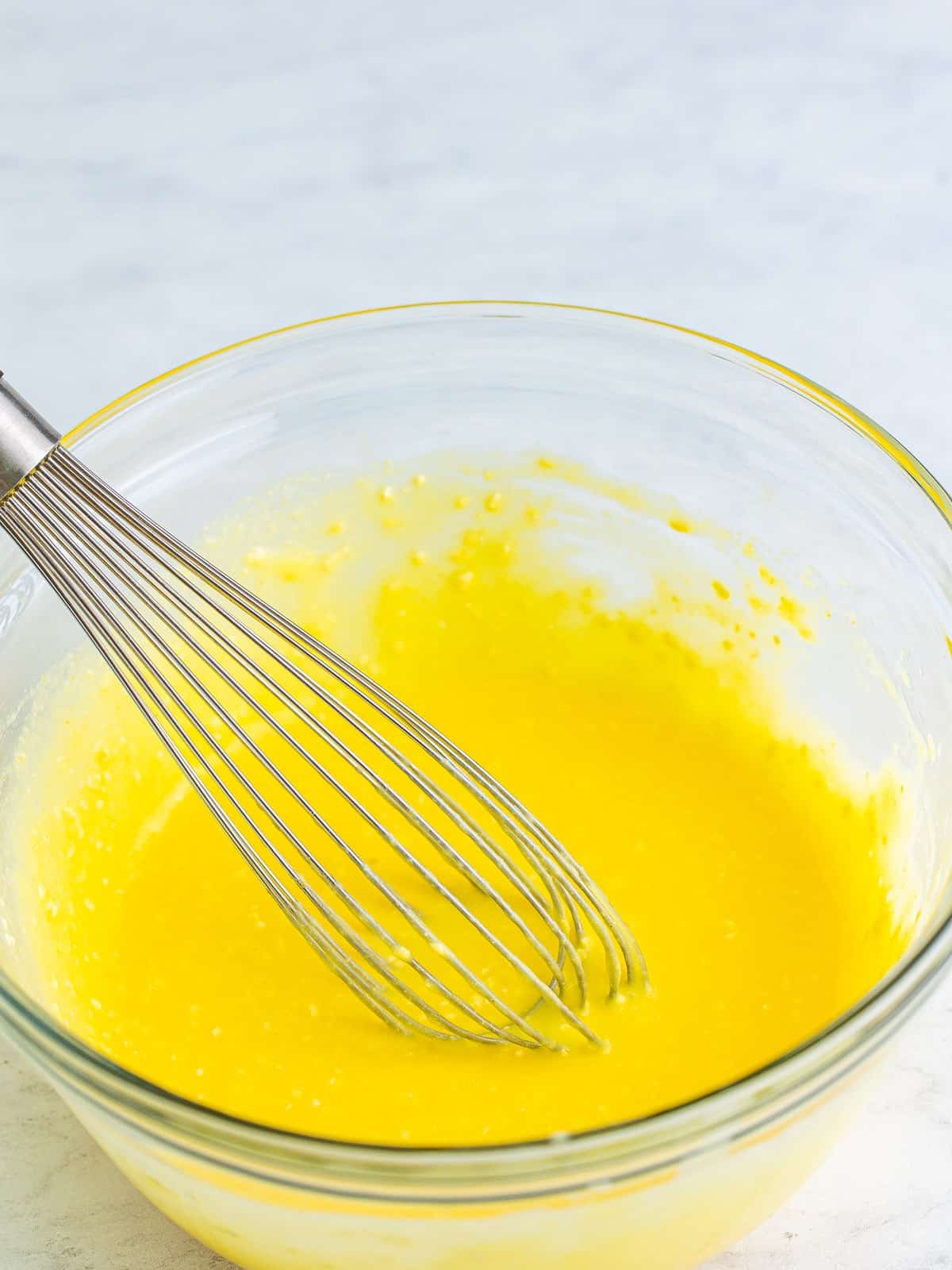 Pineapple pudding topping mixed in a bowl for Pina Colada Cake.