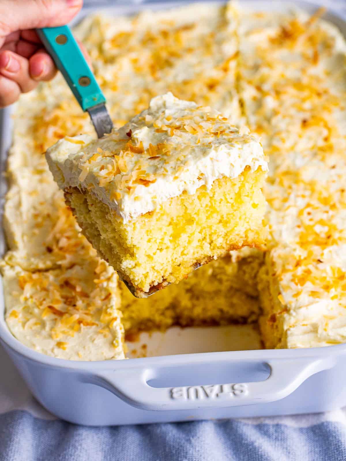 Spreading the topping over Pina Colada Cake in the pan.
