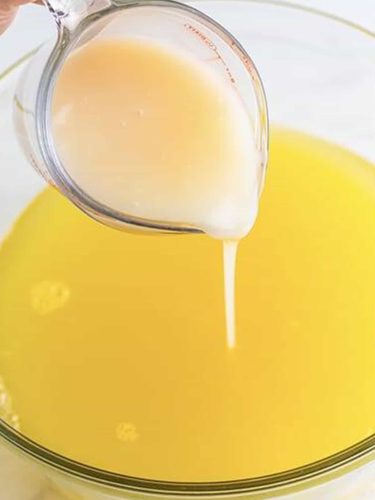 Cream of coconut poured into the pineapple lemonade mixture.
