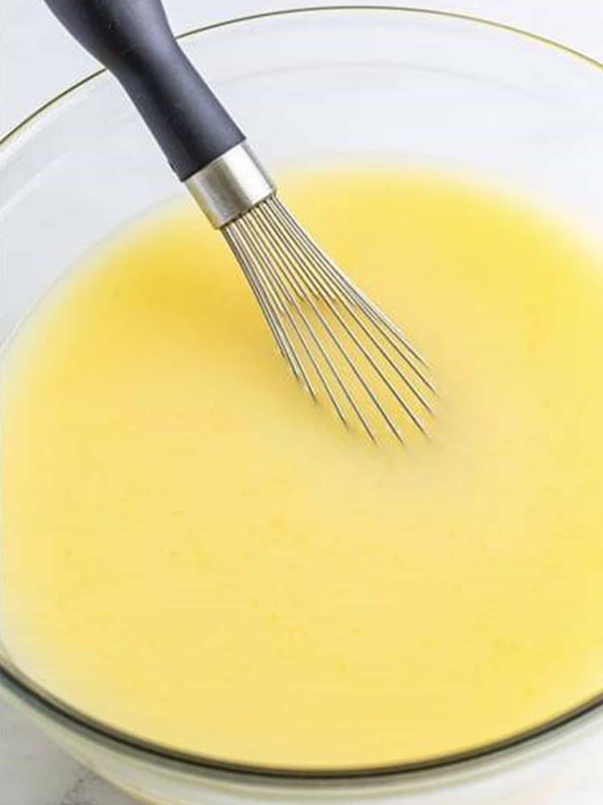 Pineapple coconut lemonade whisked together in a glass bowl before chilling.