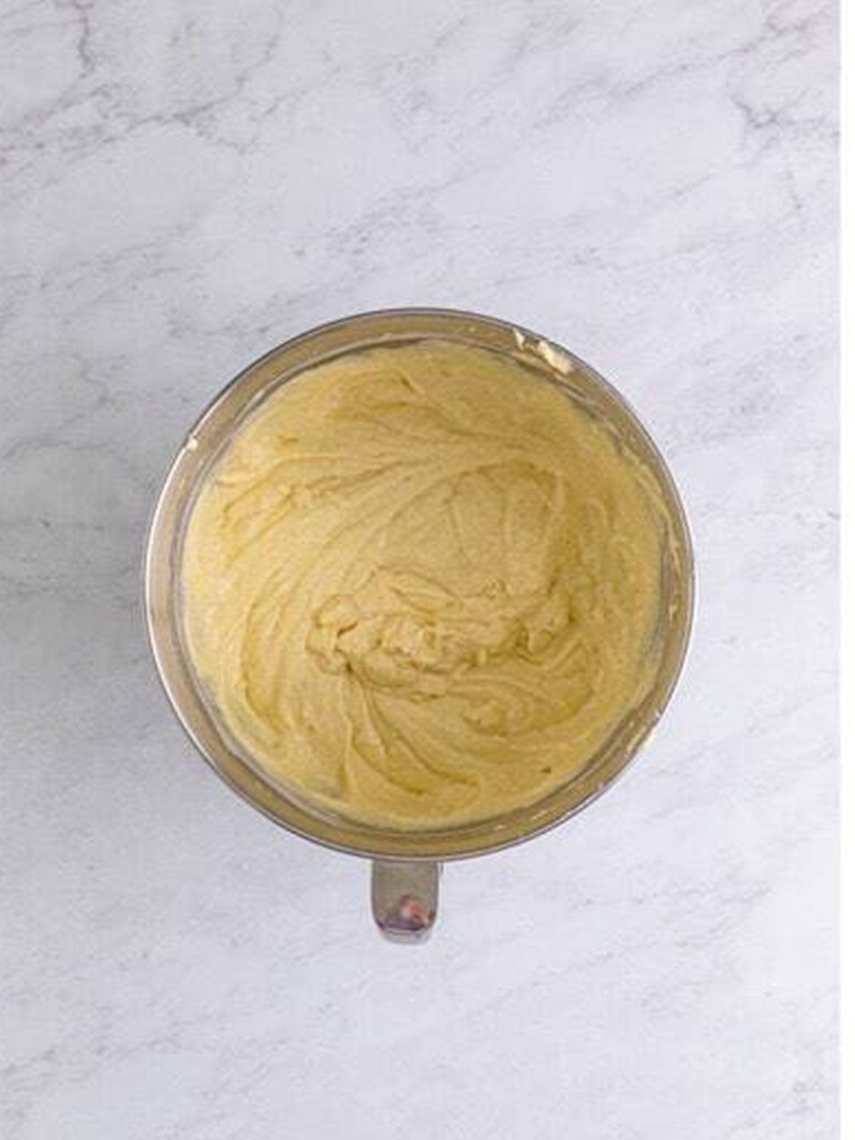 The finished pineapple cake batter in a mixing bowl.