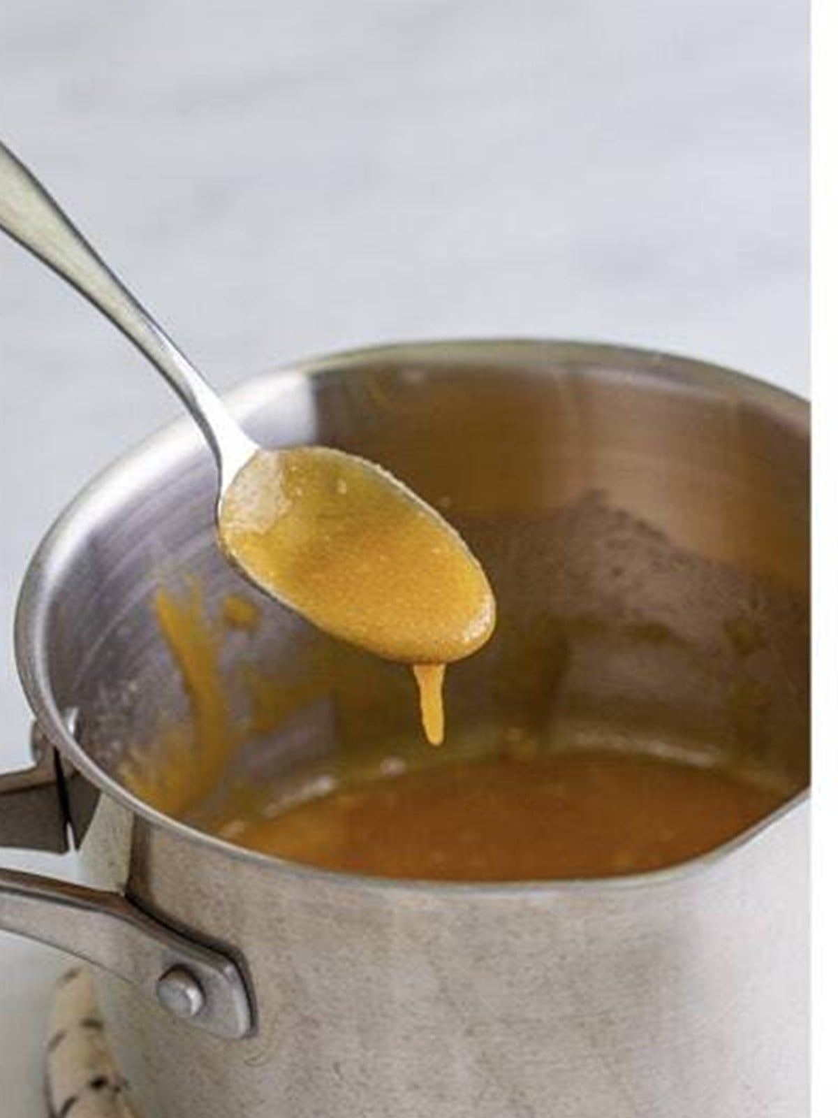Melting butter and brown sugar into a sauce for Pineapple Upside Down Cupcakes.