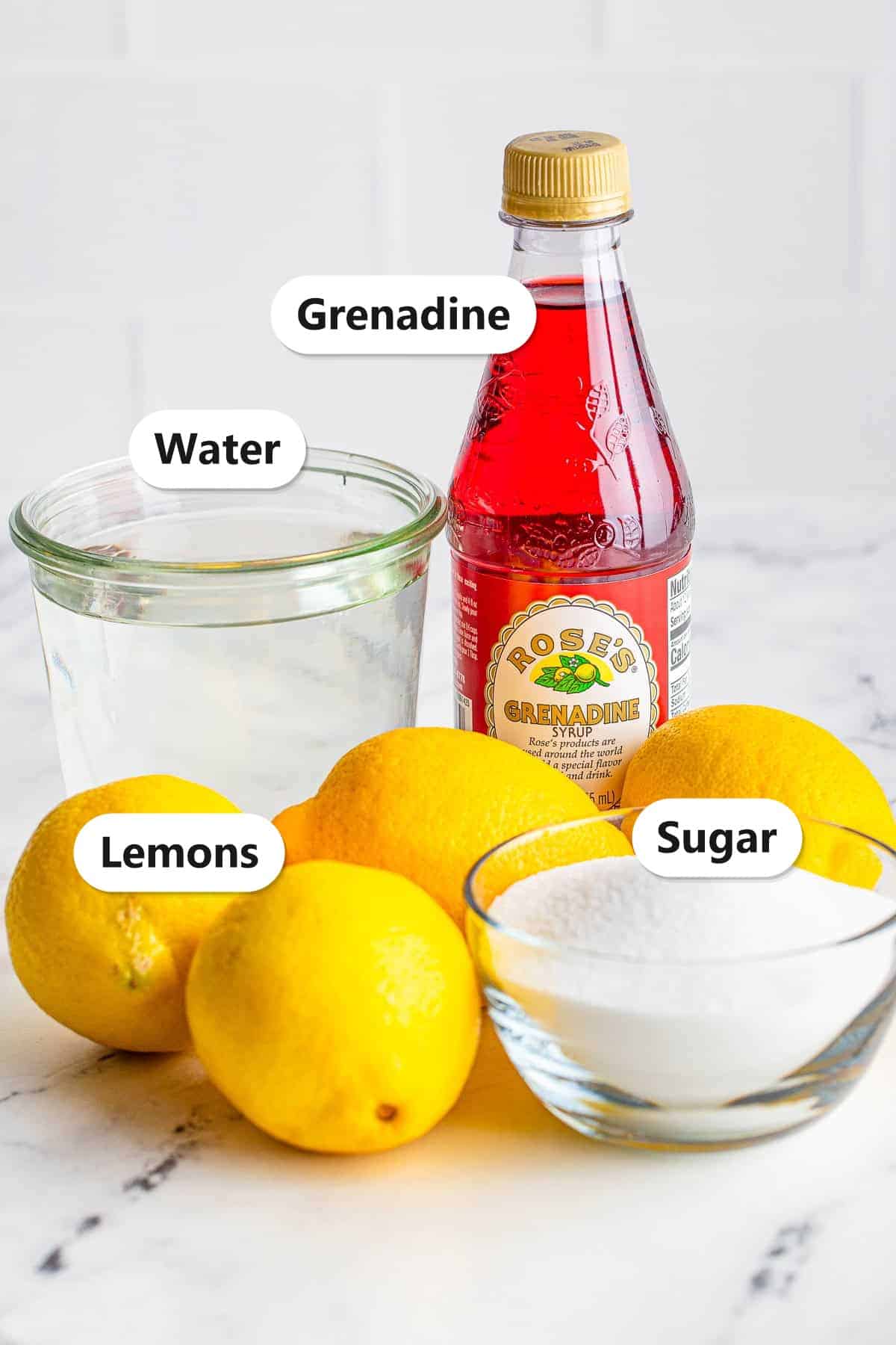 Labeled ingredients for pink lemonade including water, grenadine, fresh lemons, and sugar.