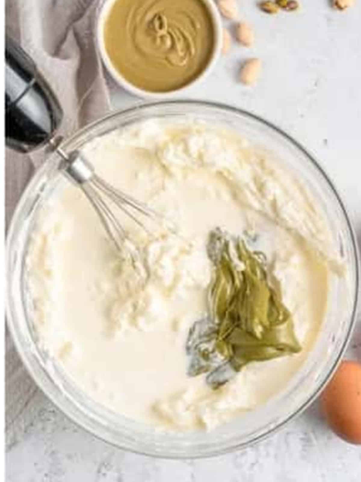 Heavy cream and pistachio spread added to the cheesecake filling.