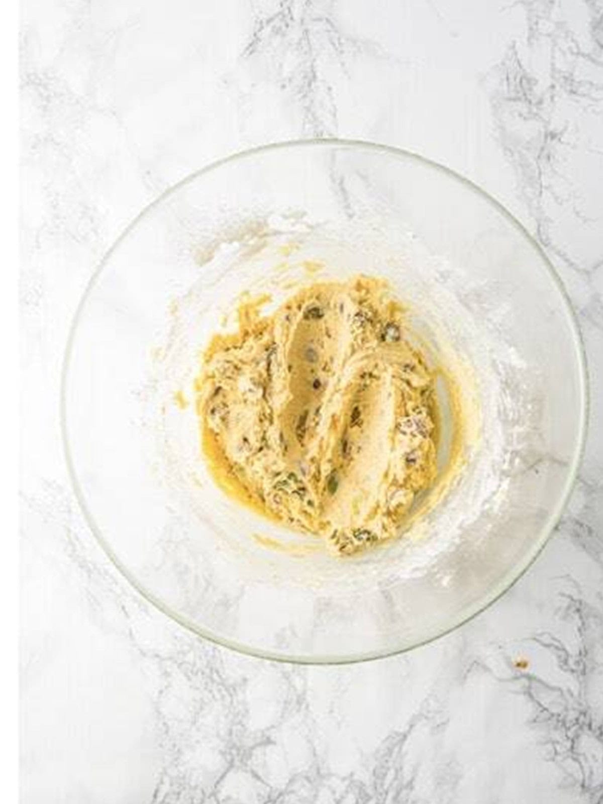 Pistachio cookie dough mixed with flour and chopped pistachios.