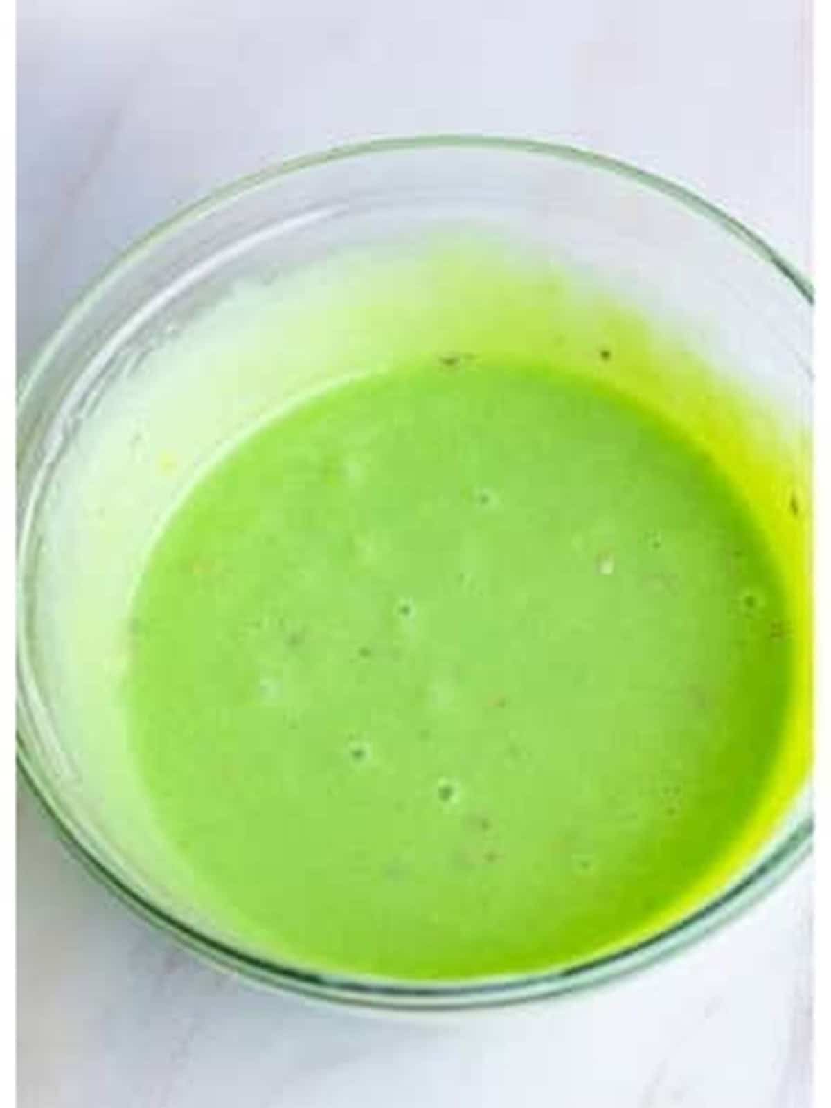 Sweetened condensed milk, pistachio pudding mix, and vanilla whisked into a green base.