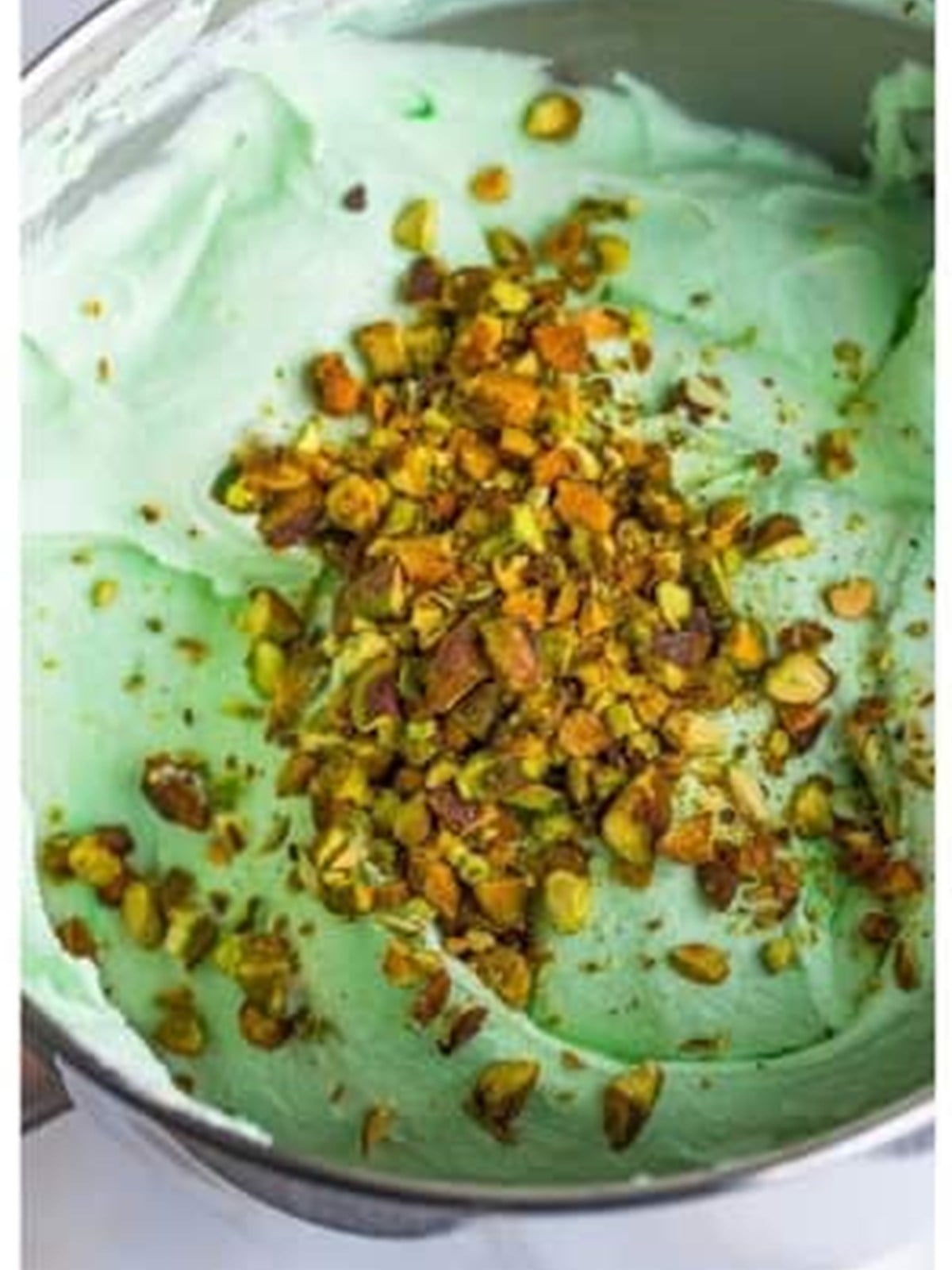 Chopped pistachios stirred into the green ice cream mixture.