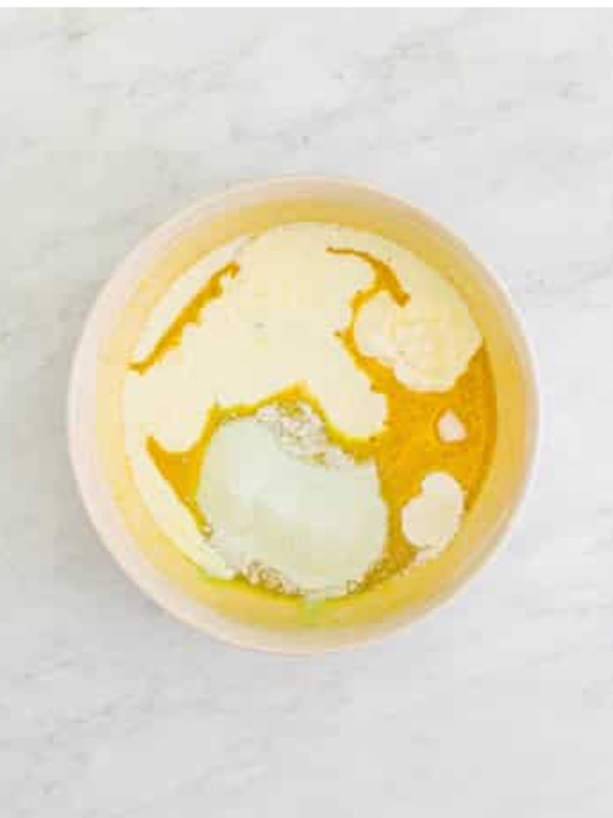 Eggs and vanilla whisked into the pistachio muffin batter base.