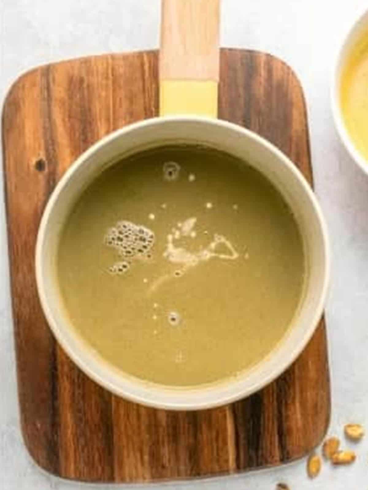 Cooking the pistachio pudding recipe over medium low heat until thickened.