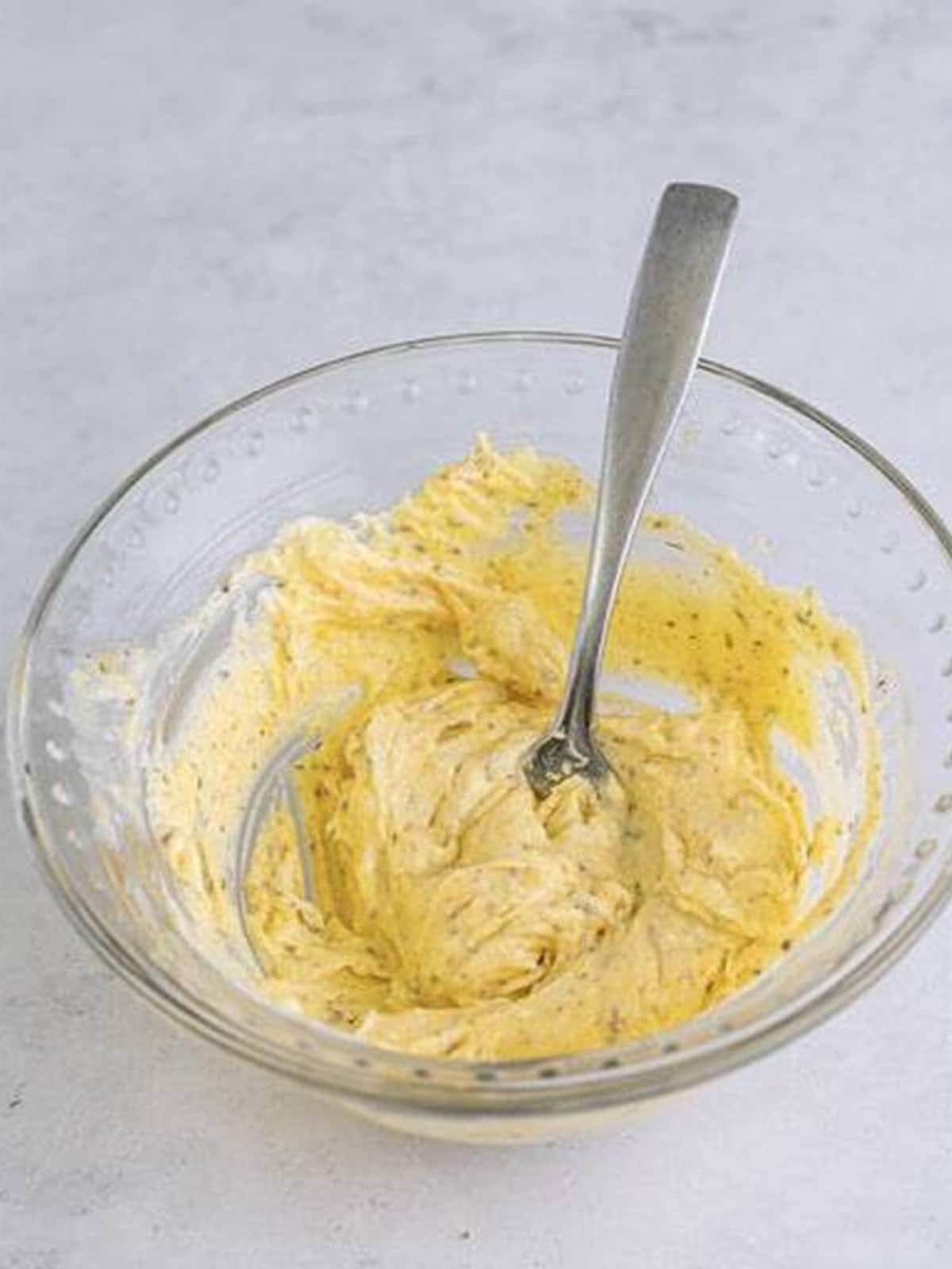 Mashing butter parmesan and Italian seasoning for a Pizza Sandwich.